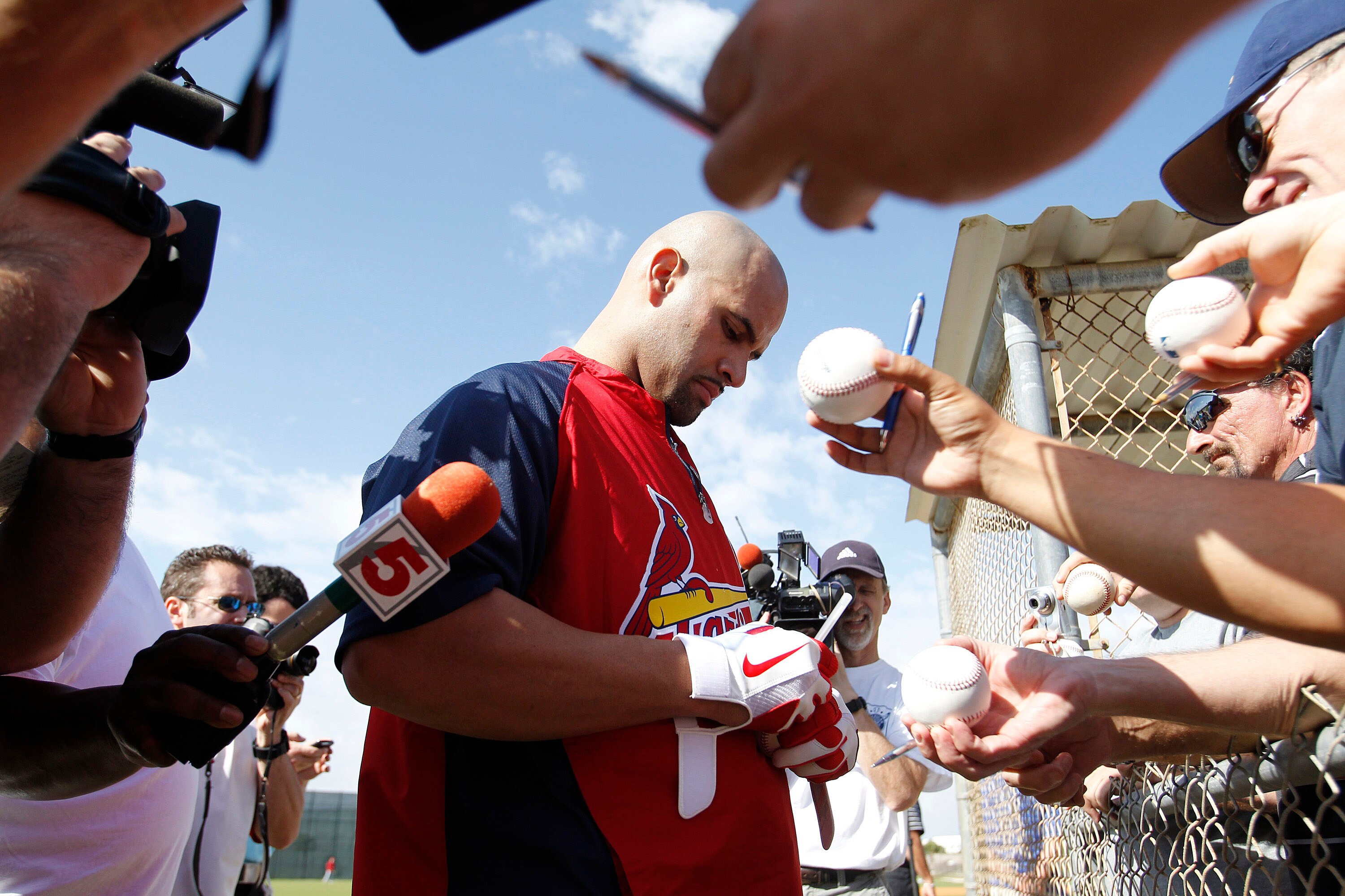 JUPITER, FL - FEBRUARY 17: Albert Pujols #5 #5 of the St. Louis Cardinals signs autographs for fans at Roger Dean Stadium on February 17, 2011 in Jupiter, Florida. (Photo by Joel Auerbach/Getty Images)