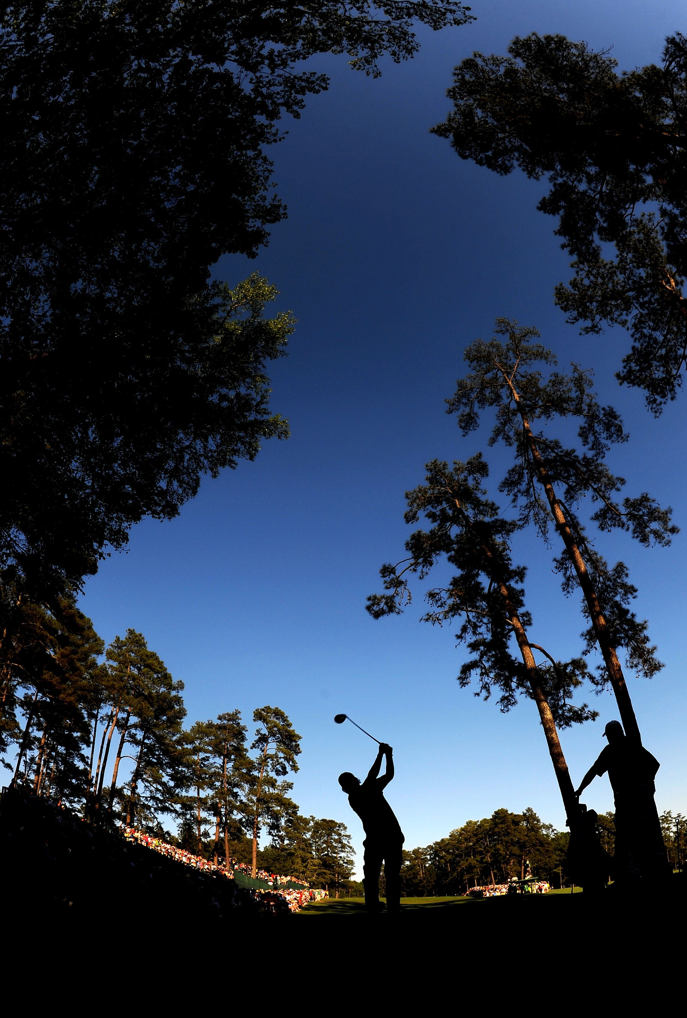 AUGUSTA, GA - APRIL 11:  Phil Mickelson plays his tee shot on the 14th hole as Lee Westwood of England looks on during the final round of the 2010 Masters Tournament at Augusta National Golf Club on April 11, 2010 in Augusta, Georgia.  (Photo by Harry How