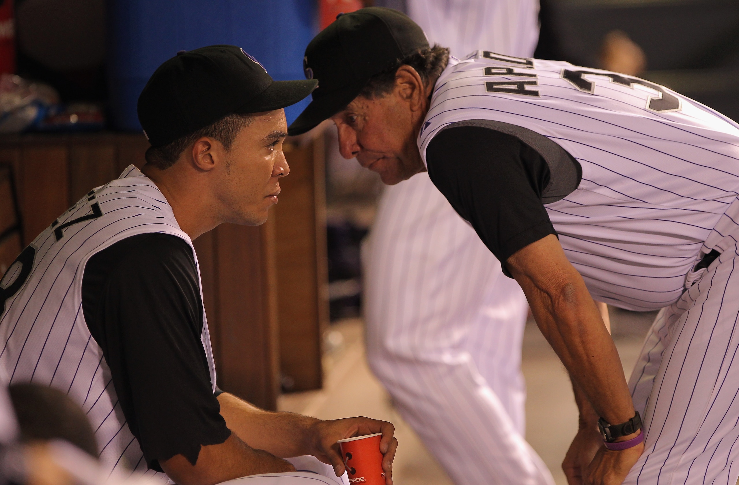 DENVER - SEPTEMBER 27:  Pitching coach Bob Apodaca #36 (R) talks with starting pitcher Ubaldo Jimenez #38 of the Colorado Rockies in the dugout at the end of the seventh inning against the Los Angeles Dodgers at Coors Field on September 25, 2010 in Denver