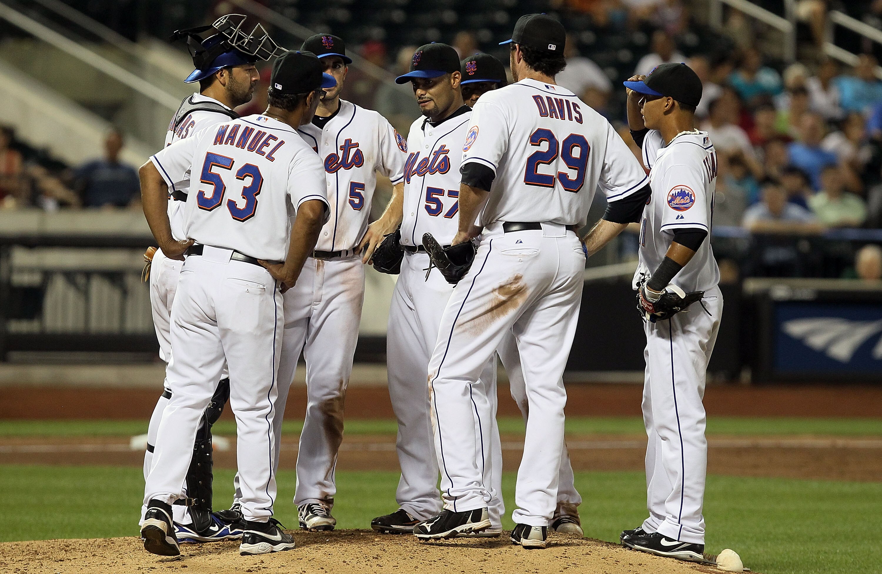 NEW YORK - JULY 06:  Manager Jerry Manuel of the New York Mets talks with Johan Santana #57 during the ninth inning against the Cincinnati Reds on July 6, 2010 at Citi Field in the Flushing neighborhood of the Queens borough of New York City. The Mets def