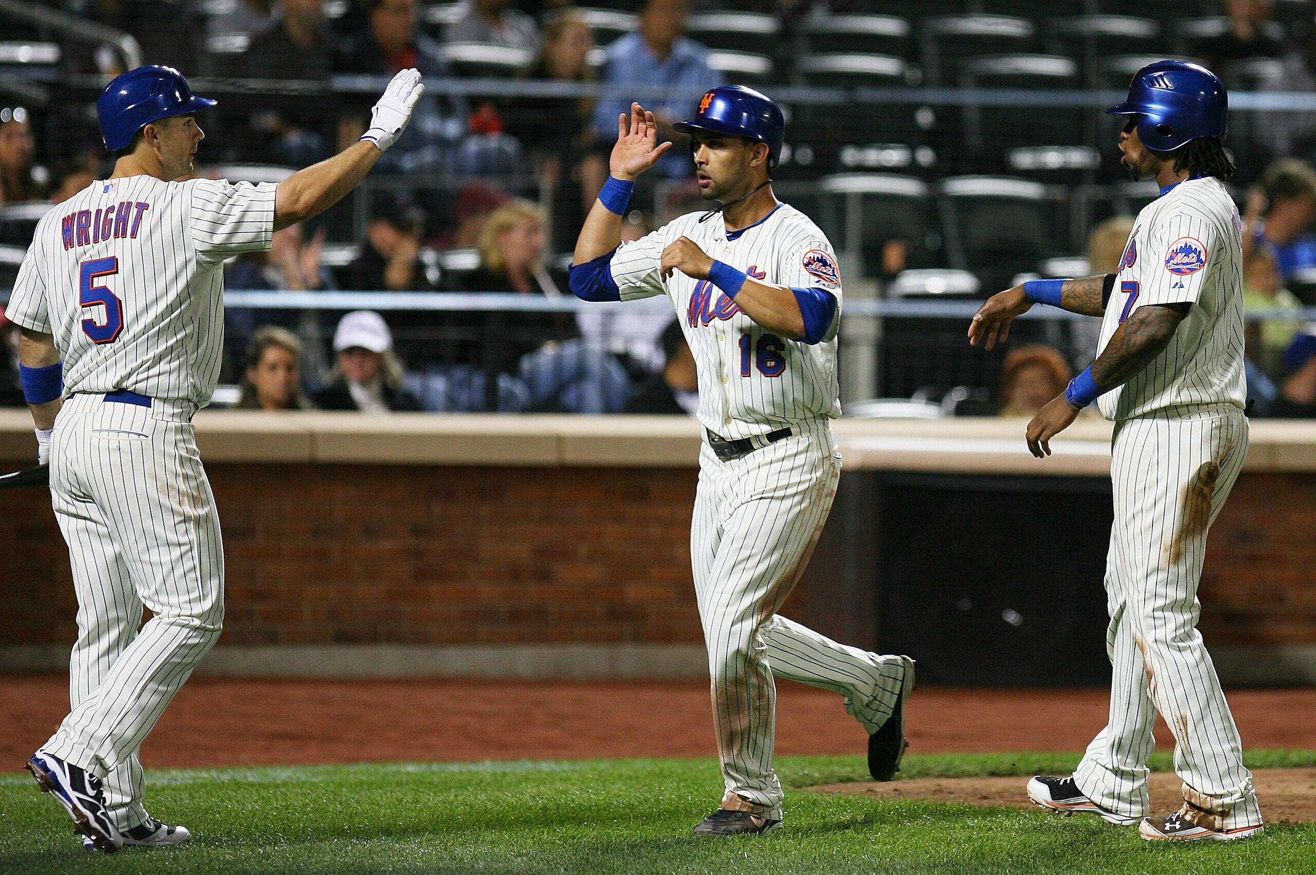 NEW YORK - SEPTEMBER 14: Angel Pagan #16 of the New York Mets is welcomed home by teammates David Wright #5 and Jose Reyes #7 after running in a two-run double hit by Carlos Beltran #15 (not seen) of the Mets in the fourth inning against the Pittsburgh Pi NEW YORK - SEPTEMBER 14: Angel Pagan #16 of the New York Mets is welcomed home by teammates David Wright #5 and Jose Reyes #7 after running in a two-run double hit by Carlos Beltran #15 (not seen) of the Mets in the fourth inning against the Pittsburgh Pi