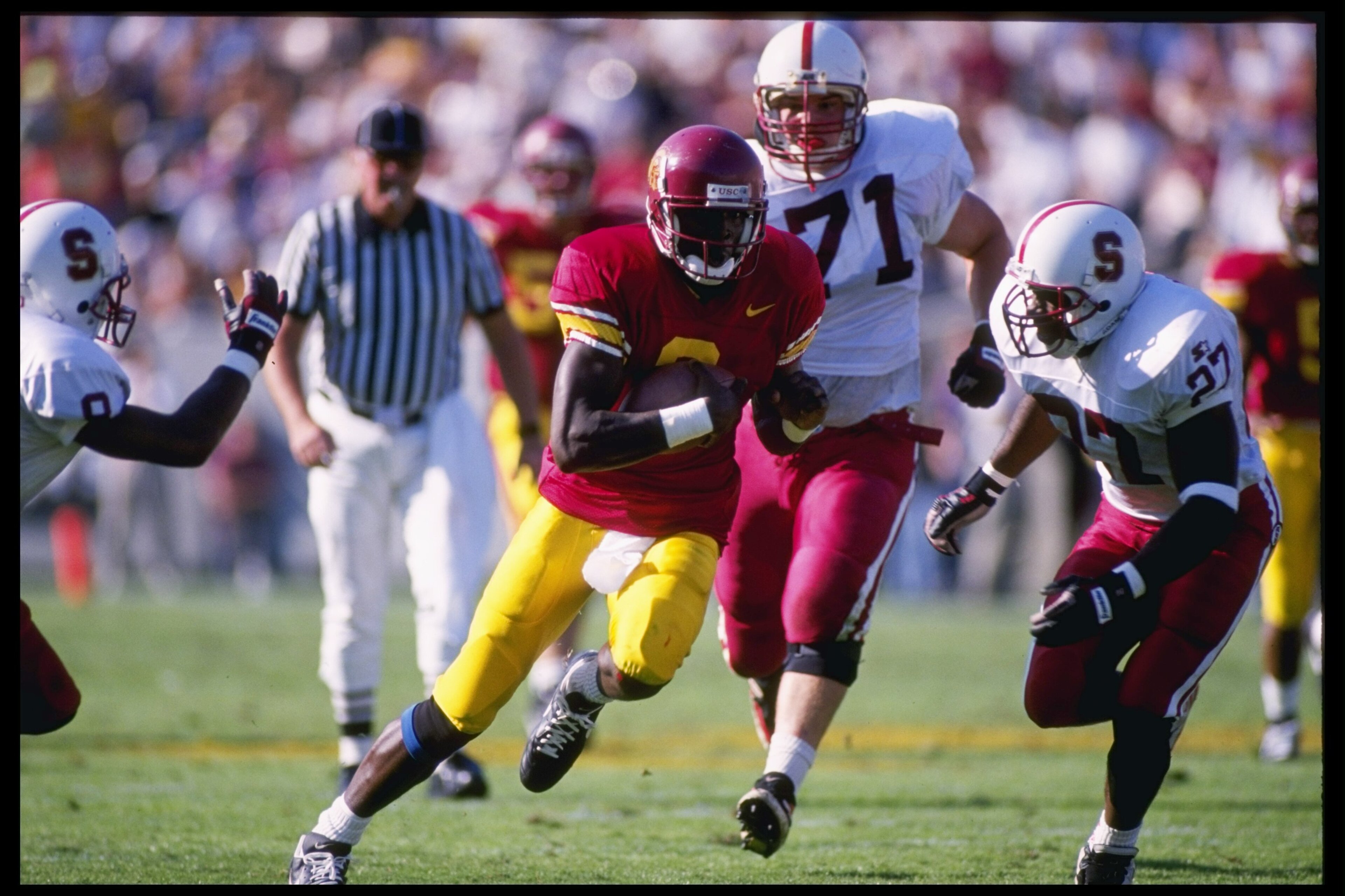 4 Nov 1995:  Runningback Keyshawn Johnson of the Southern California Trojans runs down the field as defensive back Charles Young of the Stanford Cardinals chases him during a game at Memorial Stadiun.  Southern California won the game 31-30. Mandatory Cre