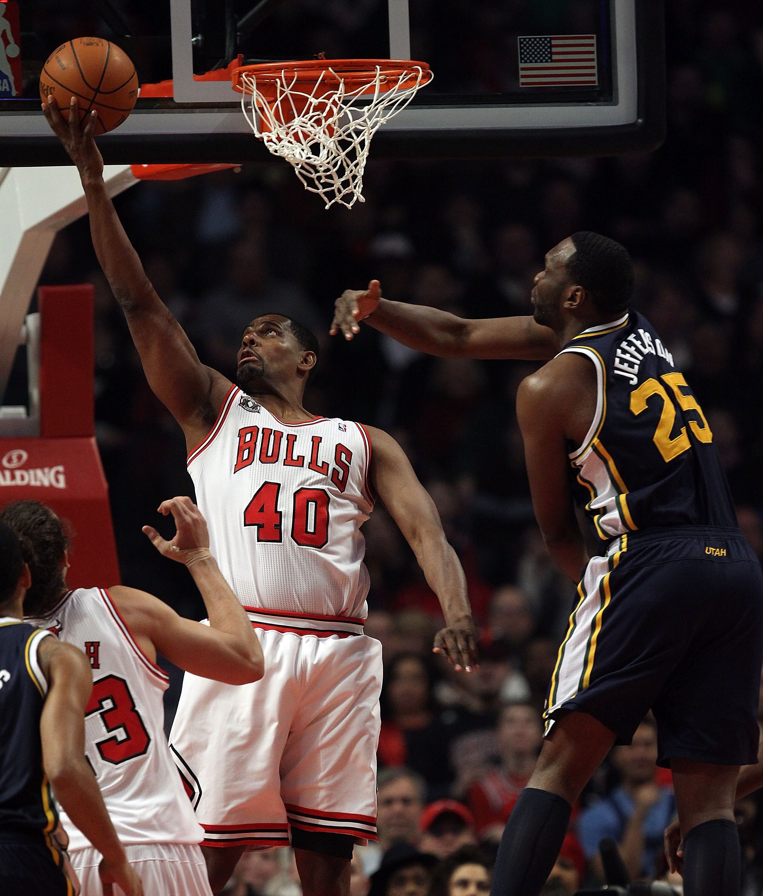 CHICAGO, IL - MARCH 12: Kurt Thomas #40 of the Chicago Bulls puts up a shot under pressure from Al Jefferson #25 of the Utah Jazz at the United Center on March 12, 2011 in Chicago, Illinois. NOTE TO USER: User expressly acknowledges and agrees that, by do