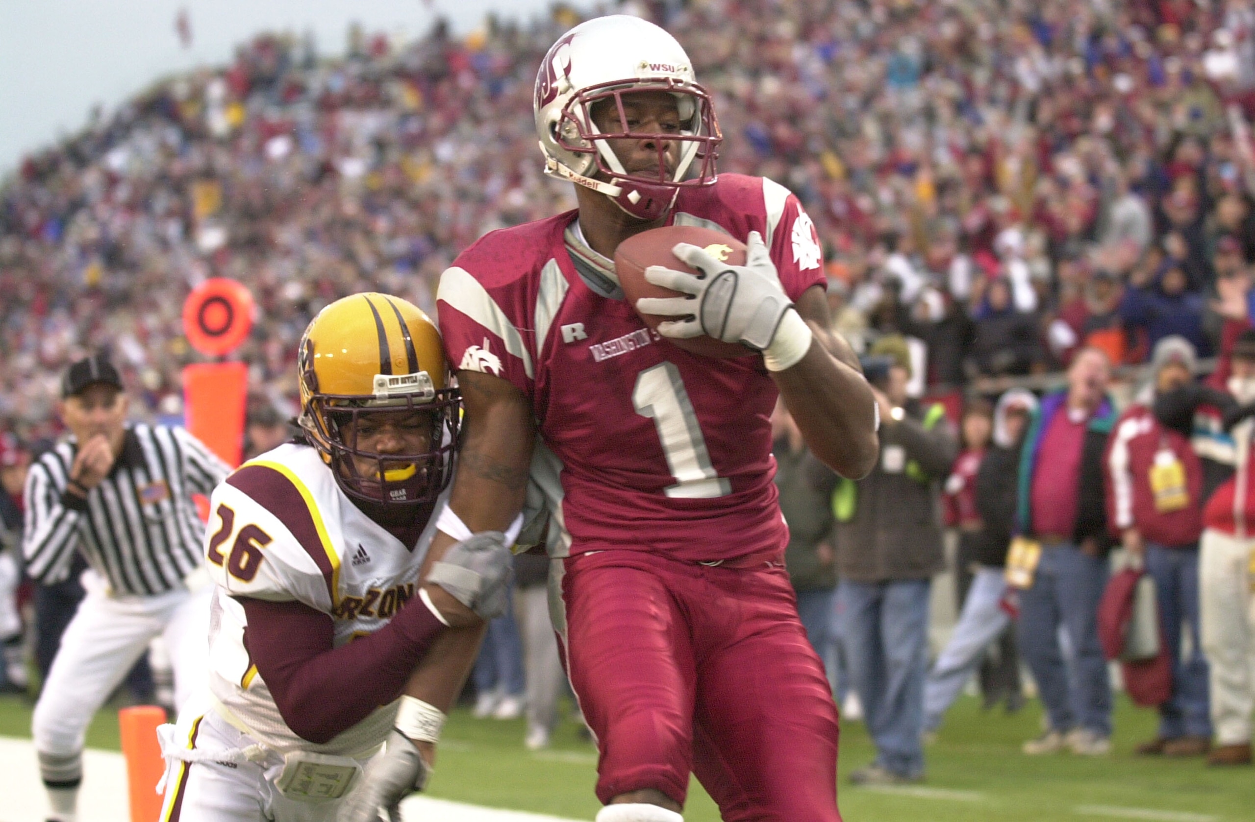 PULLMAN, WA - NOVEMBER 15:  Wide receiver Devard Darling #1 of the Washington State University Cougars scores a touchdown against R. J. Oliver #26 of the Arizona State Sun Devils on November 15, 2003 at Martin Stadium in Pullman, Washington.  (Photo by Ot