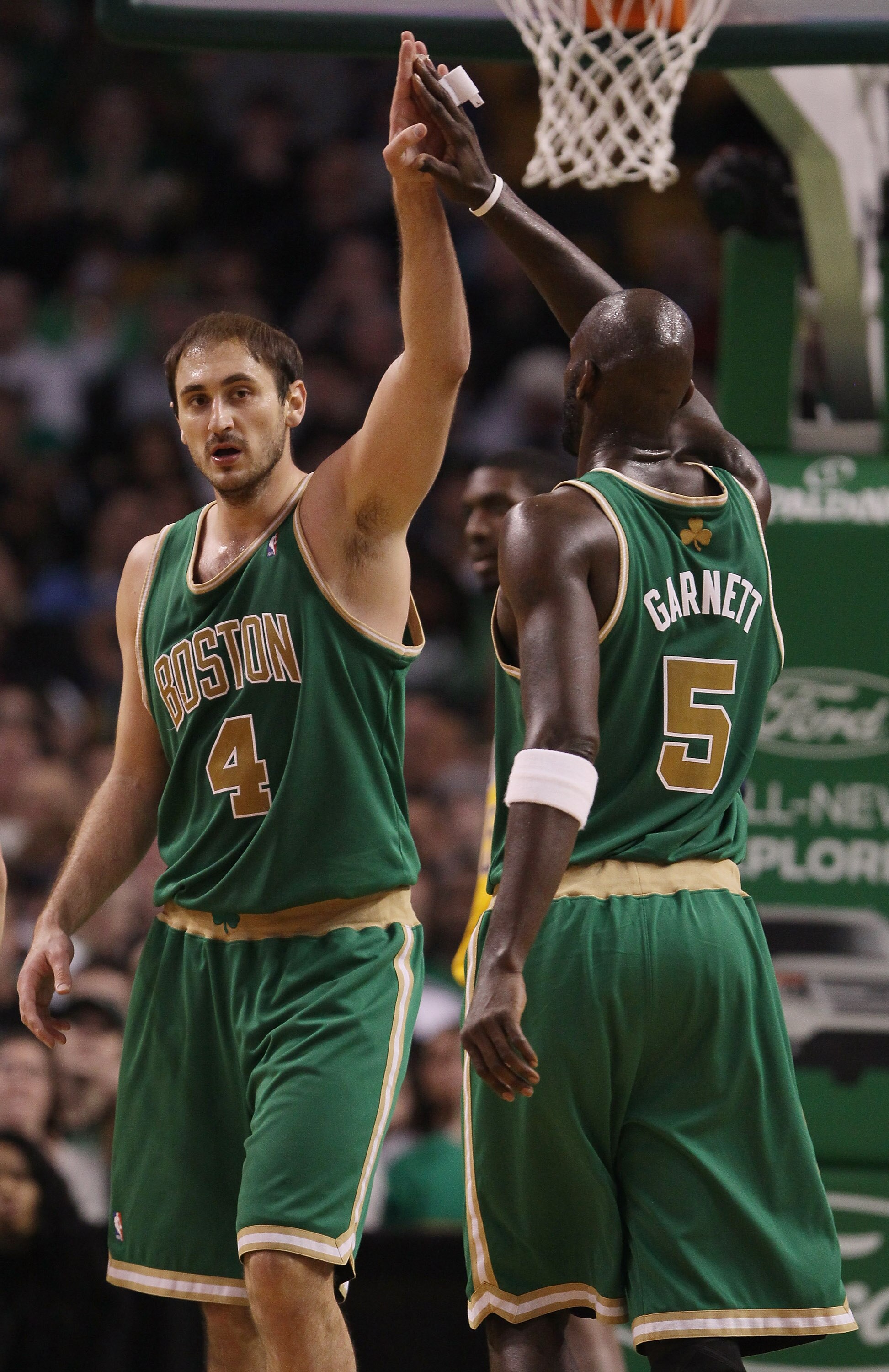 BOSTON, MA - MARCH 16:  Nenad Krstic #4 of the Boston Celtics is congratulated by teammate Kevin Garnett #5 after Krstic drew the foul in the second half against the Indiana Pacers on March 16, 2011 at the TD Garden in Boston, Massachusetts. The Celtics d