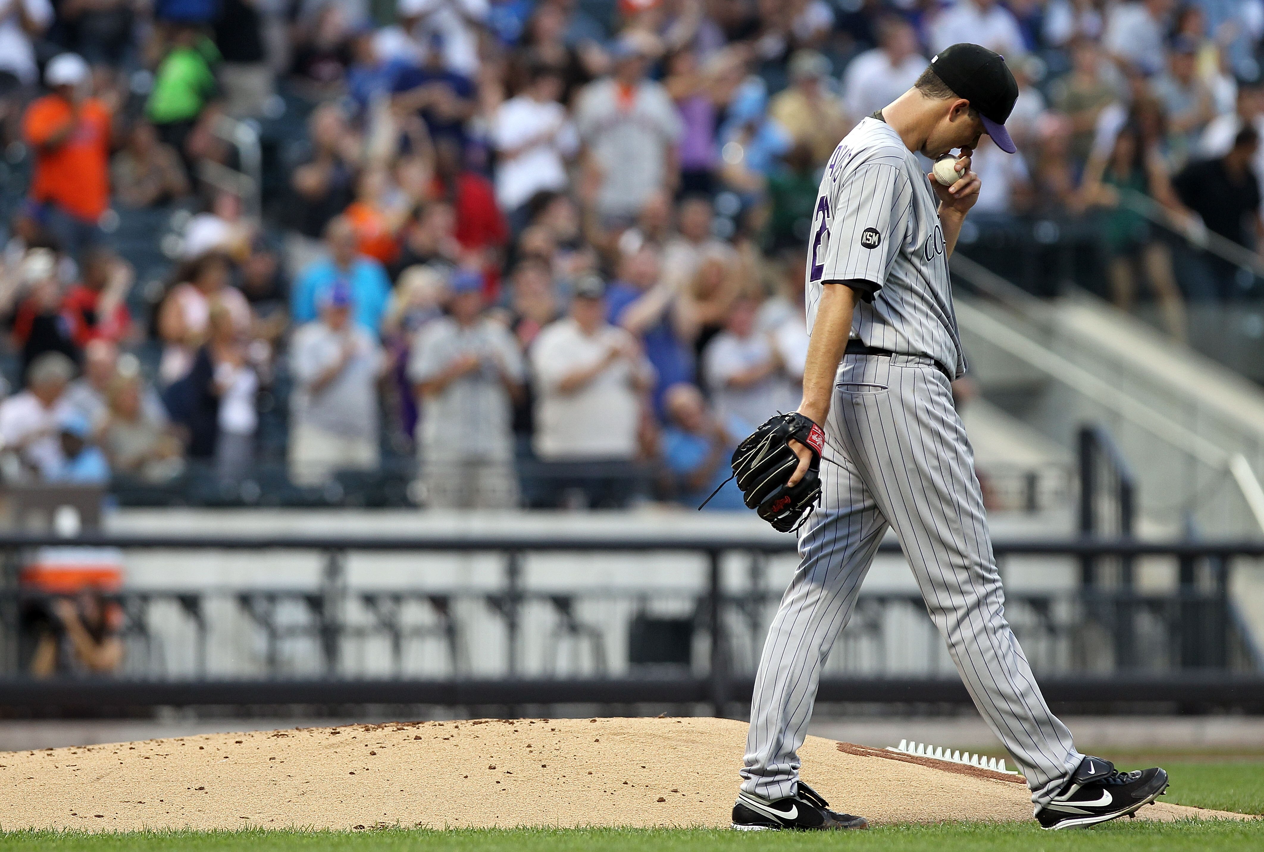 NEW YORK - AUGUST 11:  Jeff Francis #26 of the Colorado Rockies walks past the mound after giving up a two run home run in the first inning against the New York Mets at Citi Field on August 11, 2010 in the Flushing neighborhood of the Queens borough of Ne
