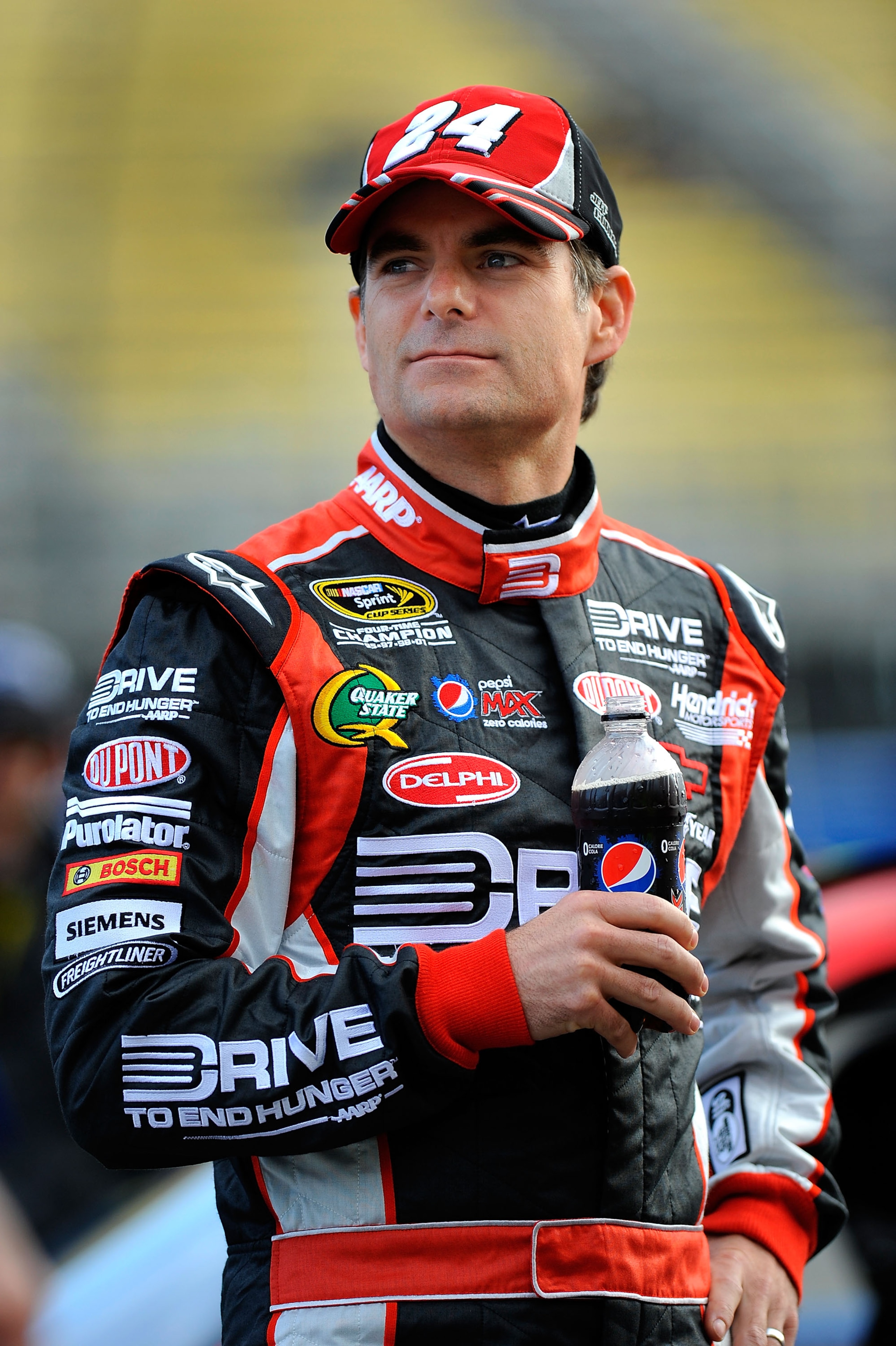 FONTANA, CA - MARCH 25:  Jeff Gordon, driver of the #24 Drive to End Hunger Chevrolet, stands on pit road during qualifying for the NASCAR Sprint Cup Series Auto Club 400 at Auto Club Speedway on March 25, 2011 in Fontana, California.  (Photo by Jared C.