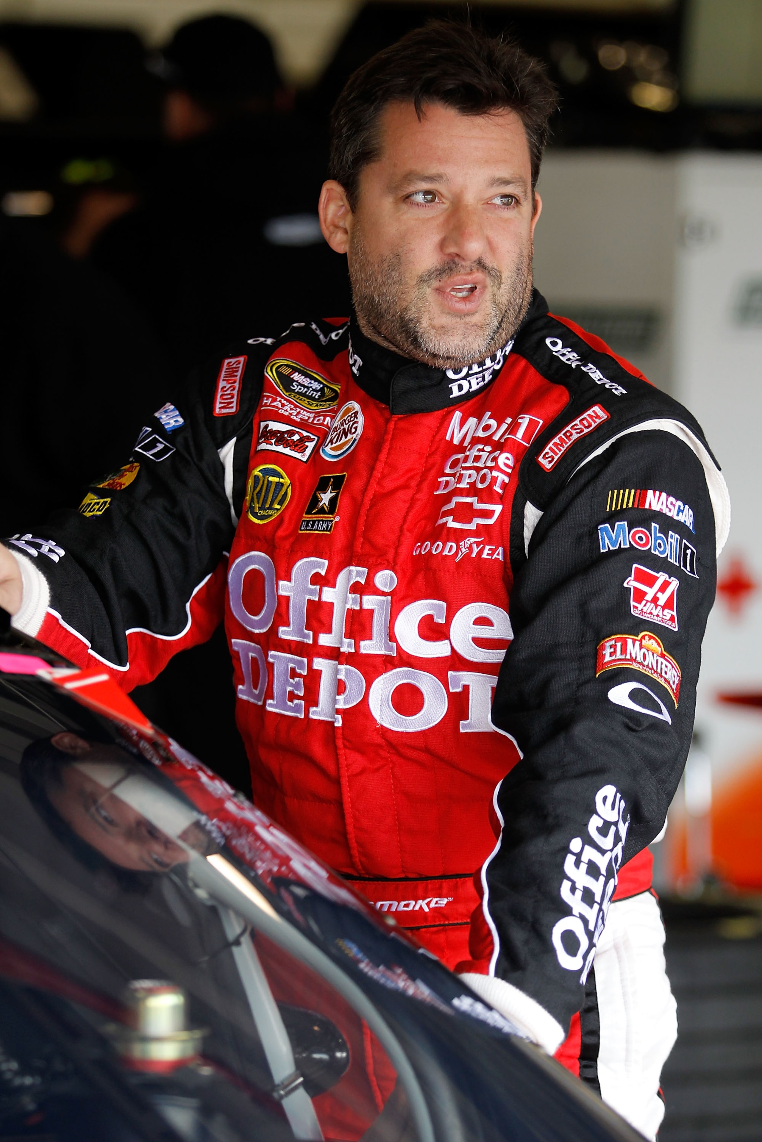 FONTANA, CA - MARCH 26:  Tony Stewart, driver of the #14 Office Depot/Mobil 1 Chevrolet, stands in the garage area during practice for the NASCAR Sprint Cup Series Auto Club 400 at Auto Club Speedway on March 26, 2011 in Fontana, California.  (Photo by To