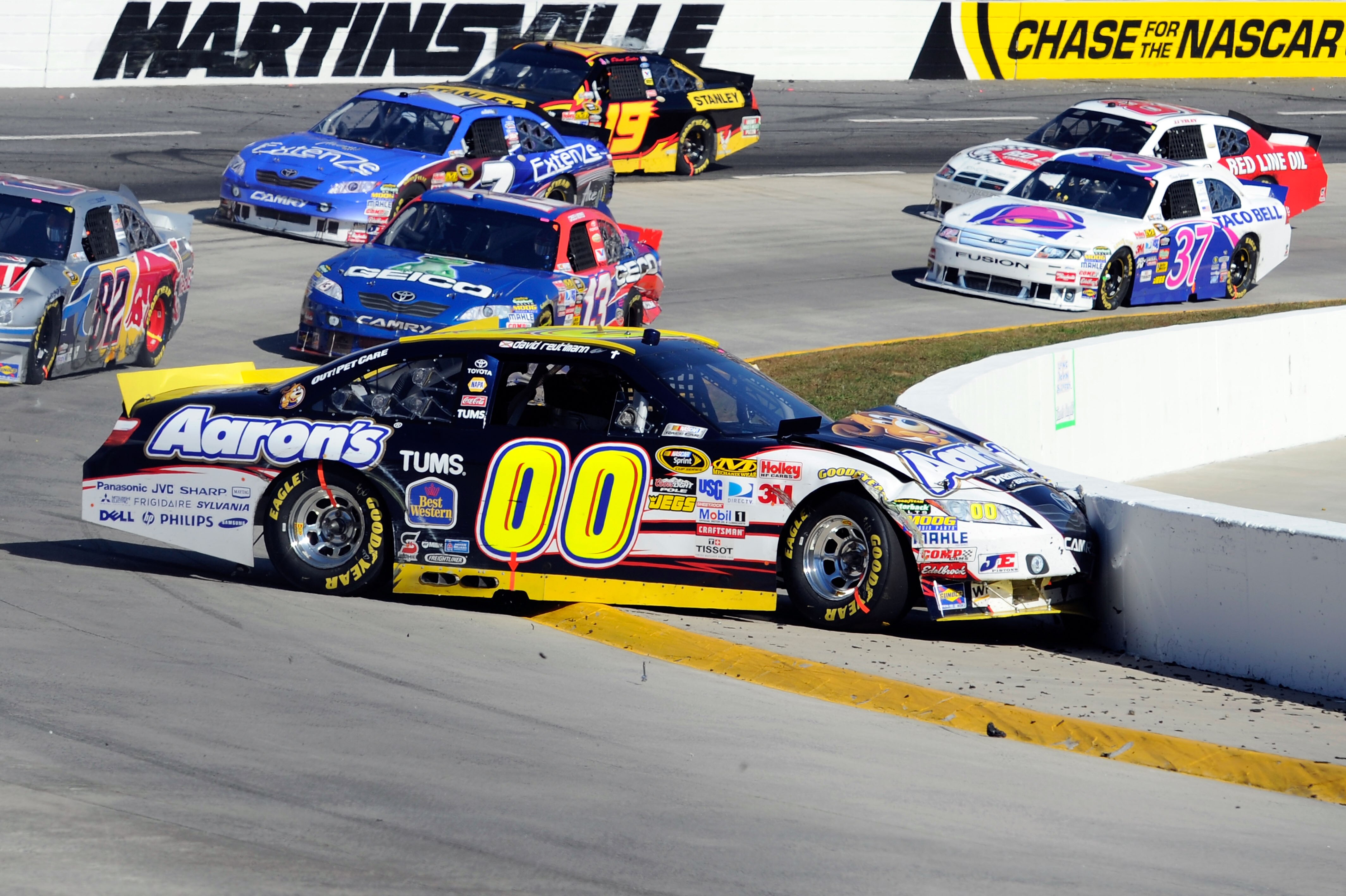 MARTINSVILLE, VA - OCTOBER 24: David Reutimann, driver of the #00 Aaron's Dream Machine Toyota, hits the wall around the inside of turn four after an incident in the NASCAR Sprint Cup Series TUMS Fast Relief 500 at Martinsville Speedway on October 24, 201