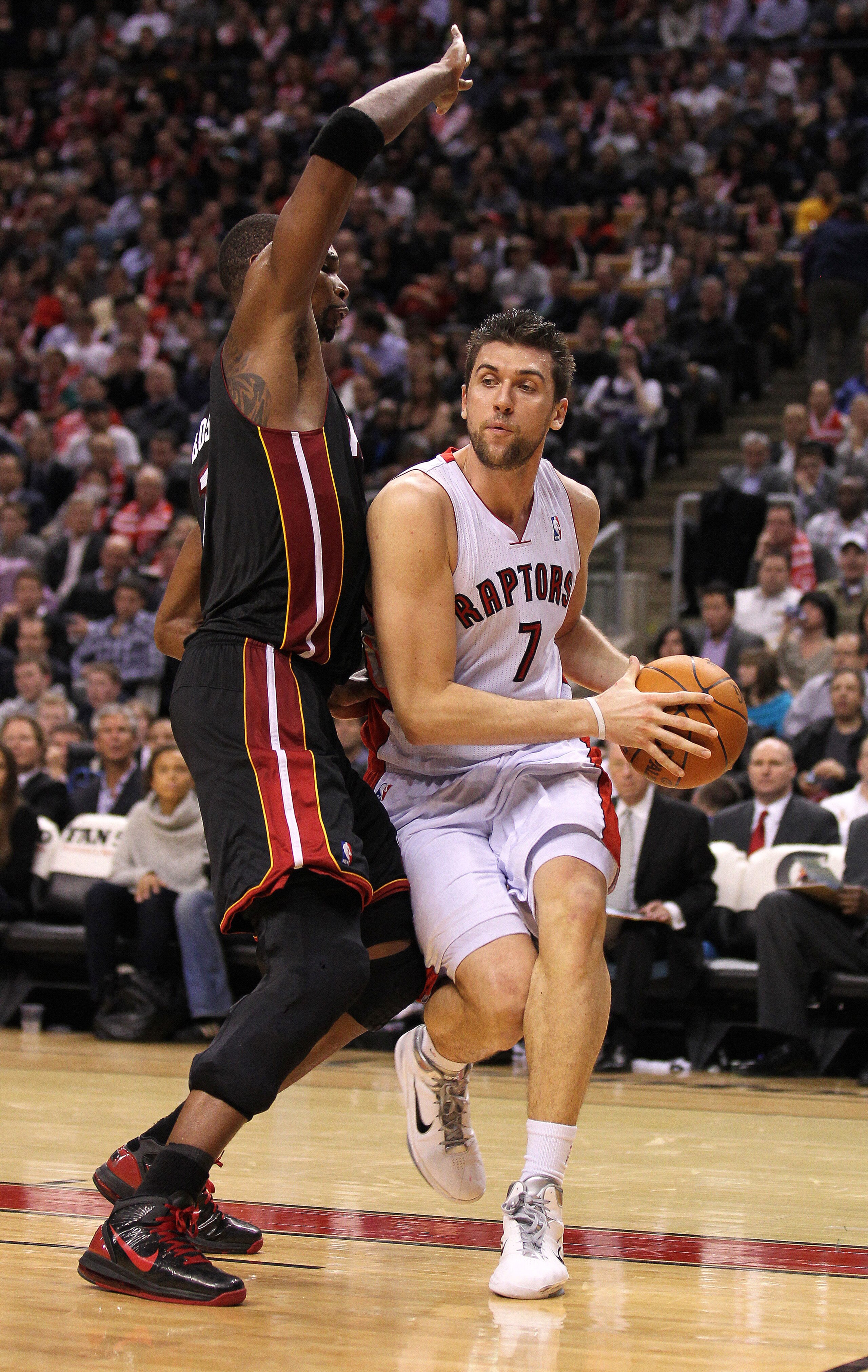 TORONTO, CANADA - FEBRUARY 16:  Chris Bosh #1 of the Miami Heat tries to defend against Andrea Bargnani #7 of the Toronto Raptors in a game on February 16, 2011 at the Air Canada Centre in Toronto, Canada. The Heat defeated the Raptors 103-95. (Photo by C