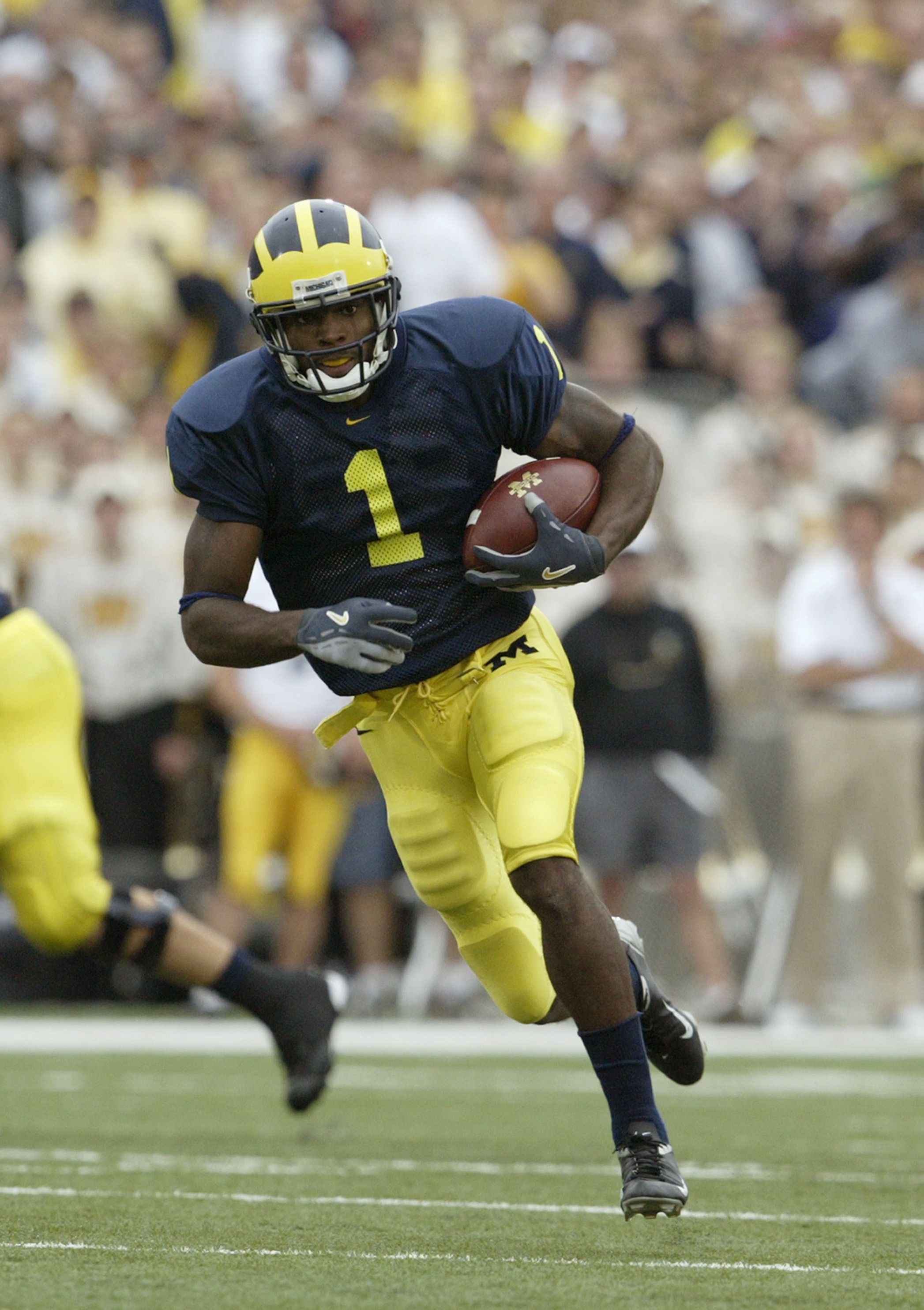 ANN ARBOR, MI - SEPTEMBER 25:  Braylon Edwards #1 of the Michigan Wolverines runs after catching a pass against the Iowa Hawkeyes during the game at Michigan Stadium on September 25, 2004 in Ann Arbor, Michigan.  Michigan defeated Iowa 30-17.  (Photo by T