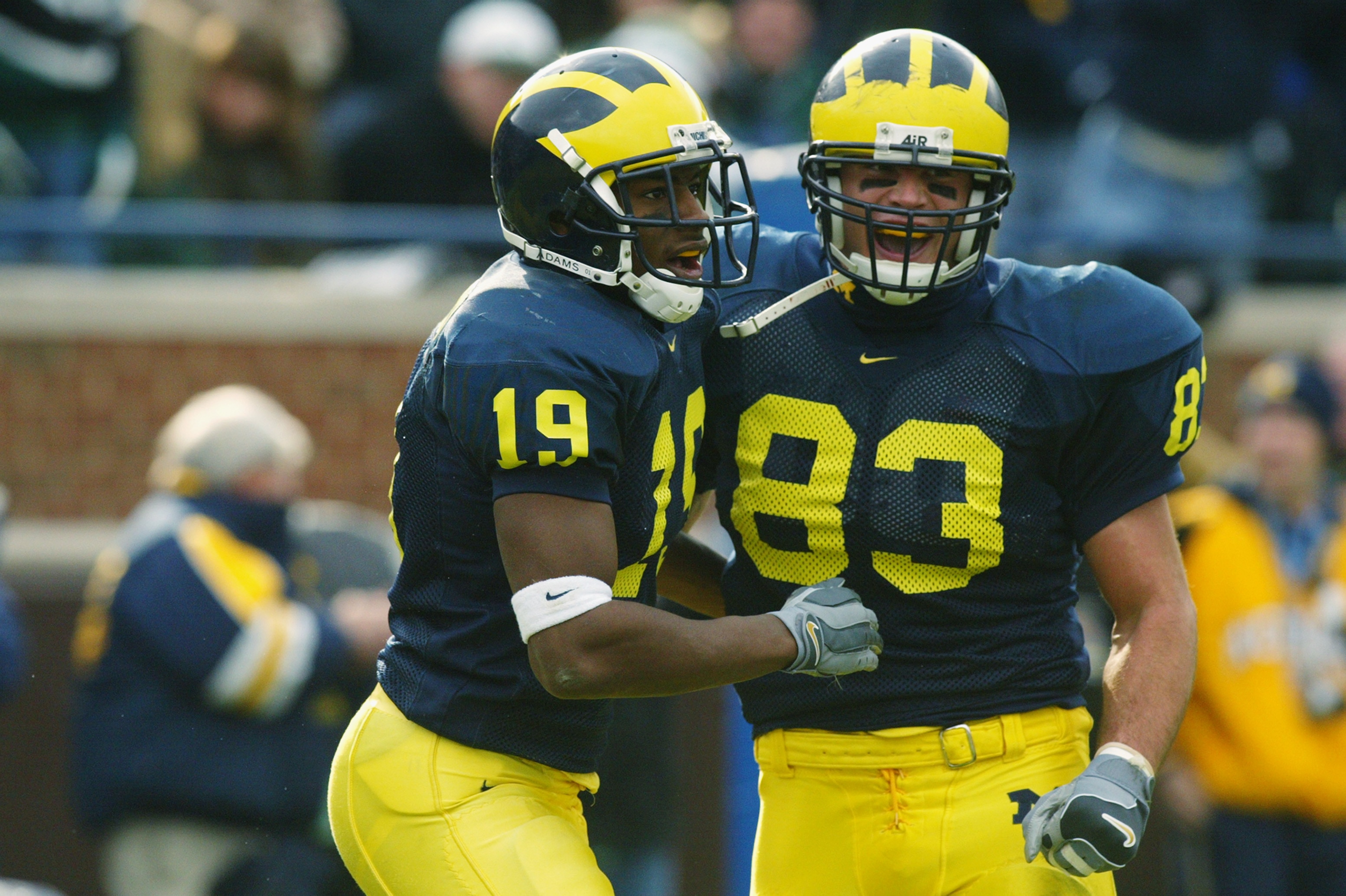 ANN ARBOR, MI - NOVEMBER 2:  Ronald Bellamy #19 of the Michigan Wolverines celebrates with Bennie Joppru #83 after Bellamy caught his second touchdown pass of the day against the Michigan State Spartans on November 2, 2002 at Michigan Stadium in Ann Arbor