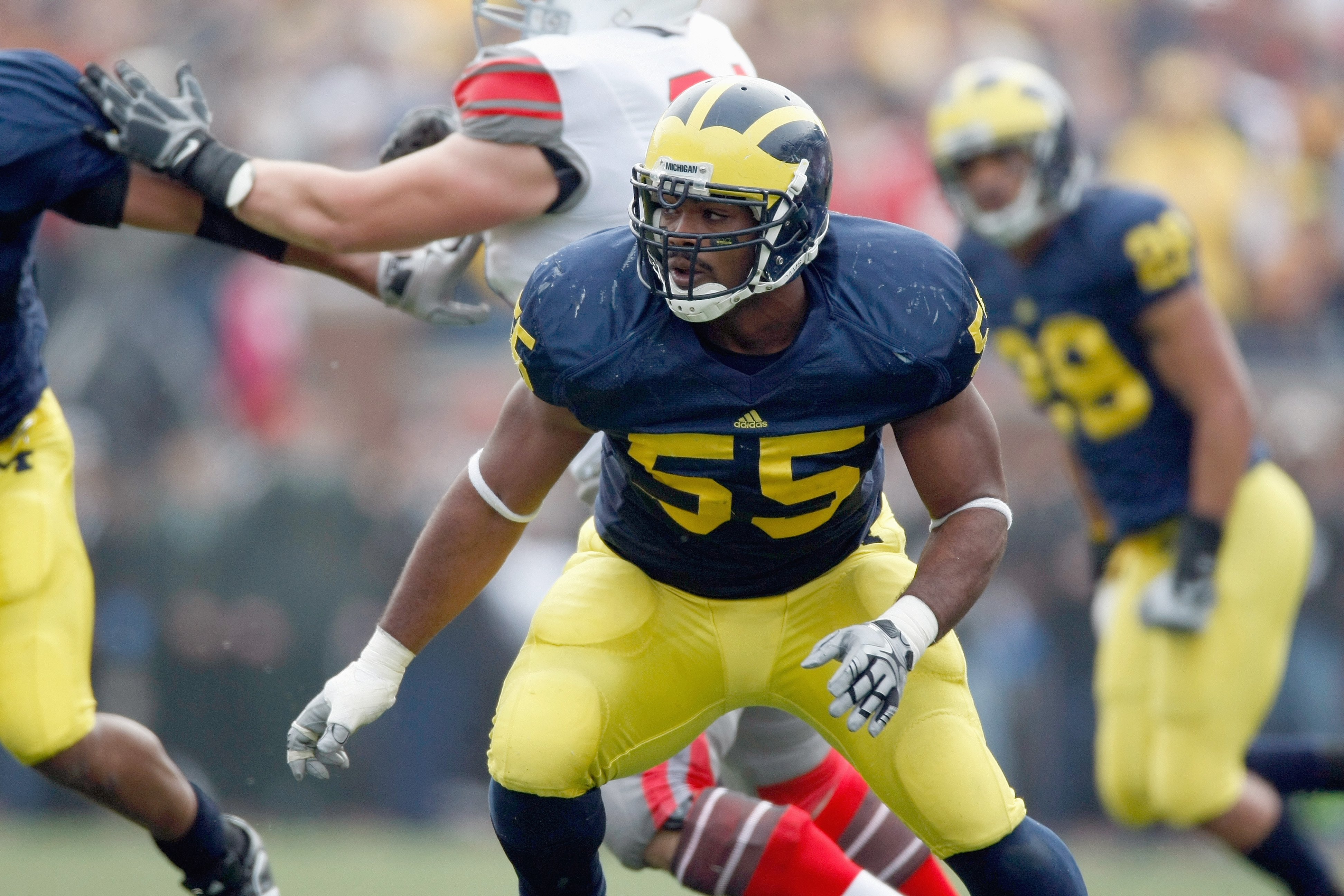 ANN ARBOR, MI - NOVEMBER 21:  Brandon Graham #55 of the Michigan Wolverines moves to blocks during the game against the Ohio State Buckeyes on November 21, 2009 at Michigan Stadium in Ann Arbor, Michigan. Ohio State won the game 21-10. (Photo by Gregory S