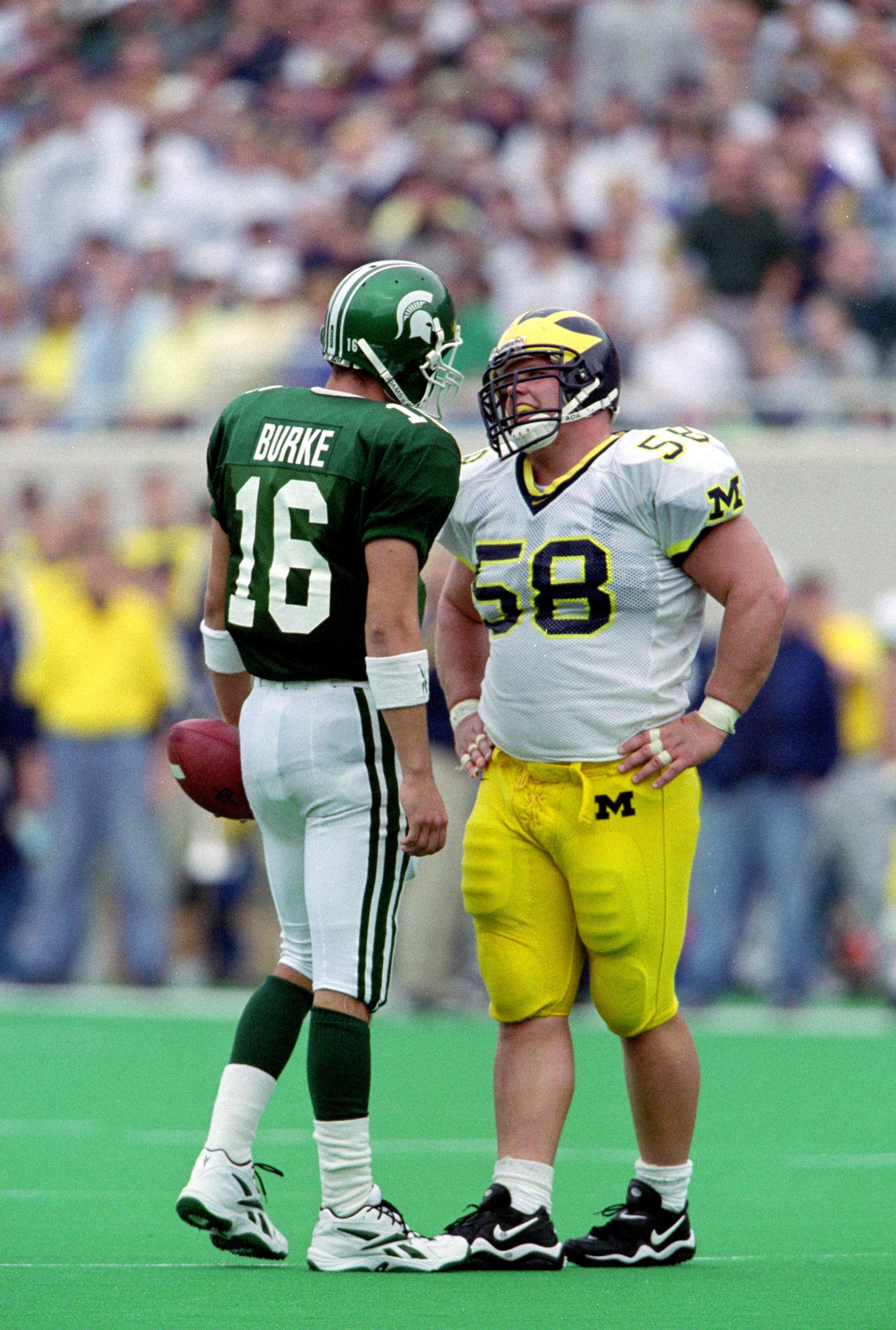 9 Oct 1999: Quarterback Bill Burke #16 of the Michigan State Spartans confronts Rob Renes #58 of the Michigan Wolverines at the Spartan Stadium in East Lansing, Michigan. The Spartans defeated the Wolverines 31-34. Mandatory Credit: Donald Miralle  /Allsp