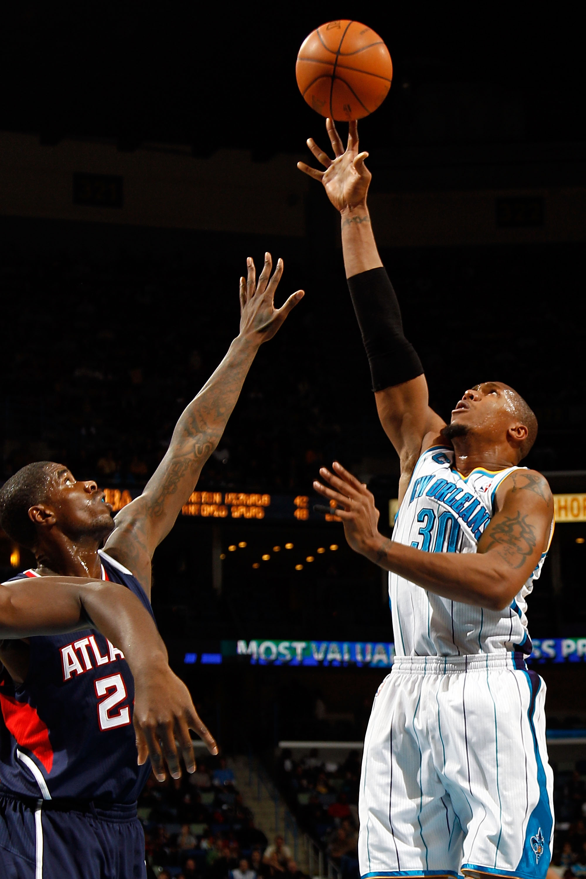 NEW ORLEANS, LA - DECEMBER 26:  David West #30 of the New Orleans Hornets shoots the ball over Joe Johnson #2 of the Atlanta Hawks at the New Orleans Arena on December 26, 2010 in New Orleans, Louisiana.  NOTE TO USER: User expressly acknowledges and agre