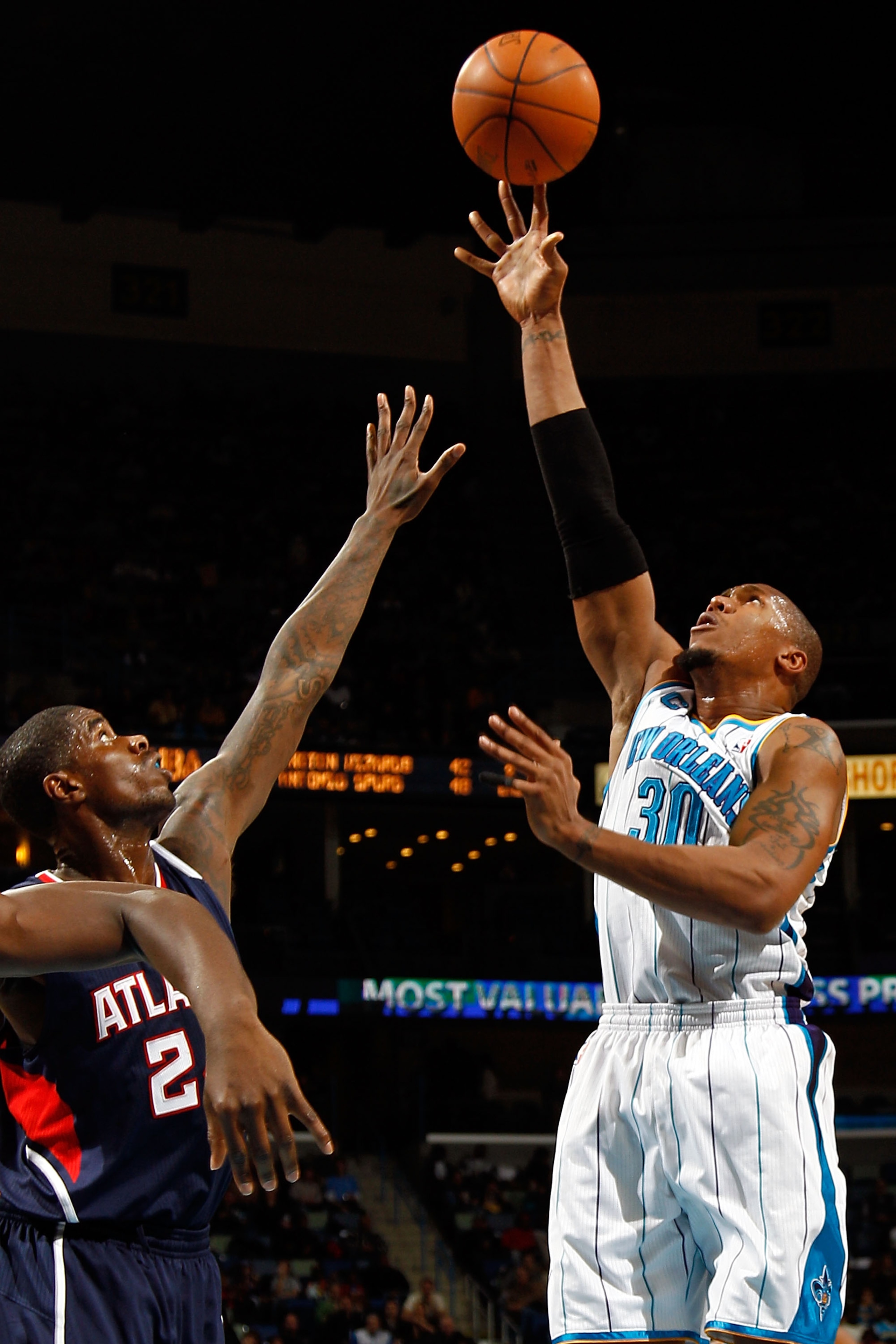 NEW ORLEANS, LA - DECEMBER 26:  David West #30 of the New Orleans Hornets shoots the ball over Joe Johnson #2 of the Atlanta Hawks at the New Orleans Arena on December 26, 2010 in New Orleans, Louisiana.  NOTE TO USER: User expressly acknowledges and agre