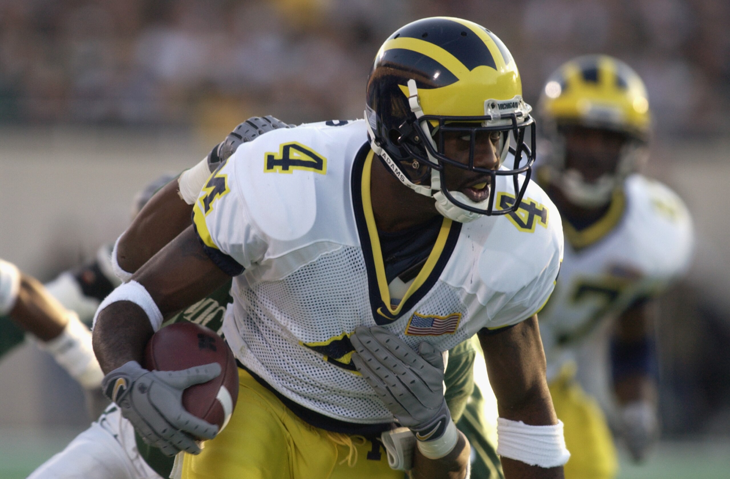 EAST LANSING, MI - NOVEMBER 3:  Wide receiver Marquise Walker #4 of the Michigan Wolverines runs with the ball during the Big Ten Conference football game against the Michigan State Spartans on November 3, 2001 at Spartan Stadium in East Lansing, Michigan