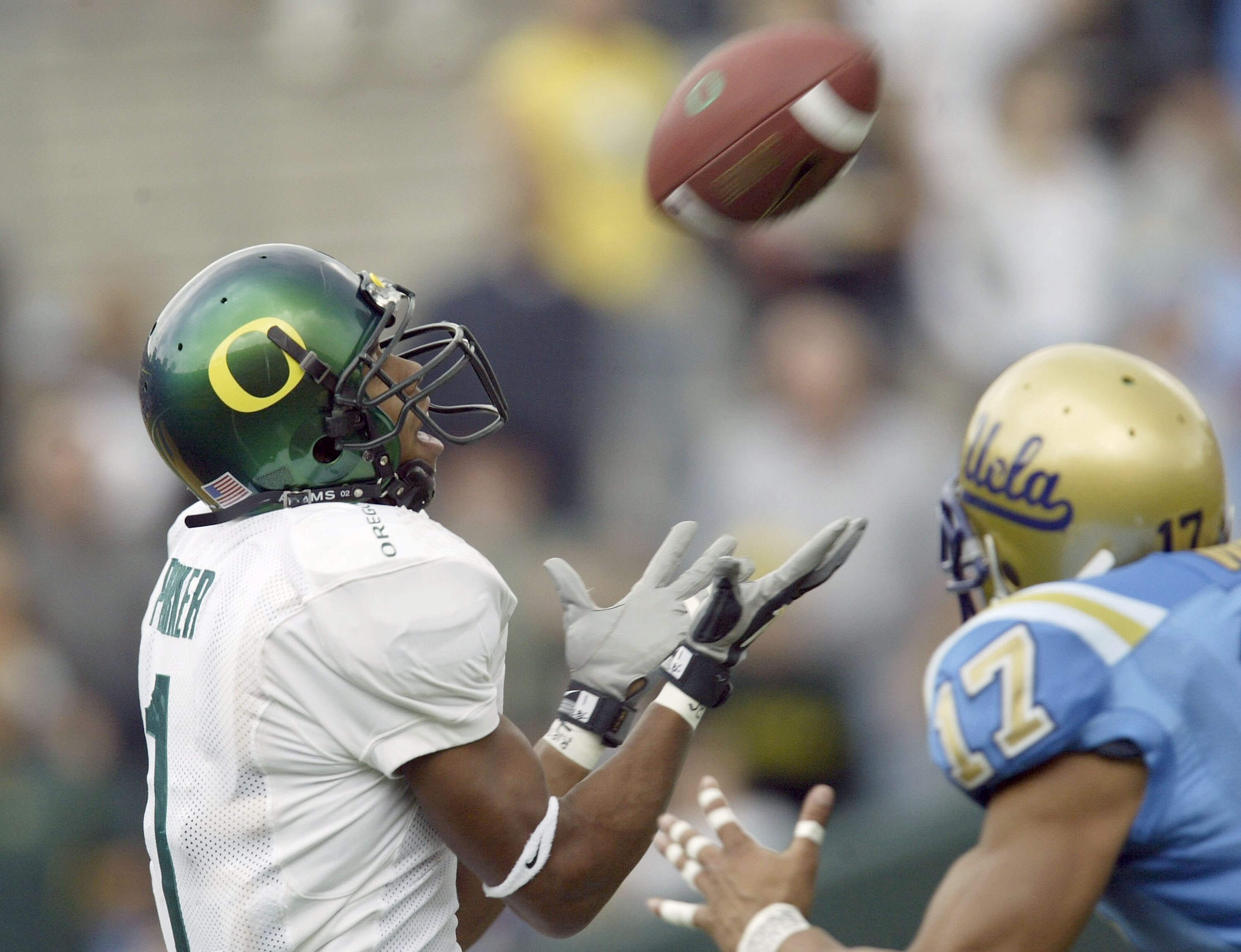 PASADENA, CA - NOVEMBER 15:  Wide receiver Samie Parker of the Oregon Ducks catches a long touchdown pass in front of defensive back Matt Ware #17 of the UCLA Bruins on November 15, 2003 at the Rose Bowl in Pasadena, California.   (Photo by Stephen Dunn/G