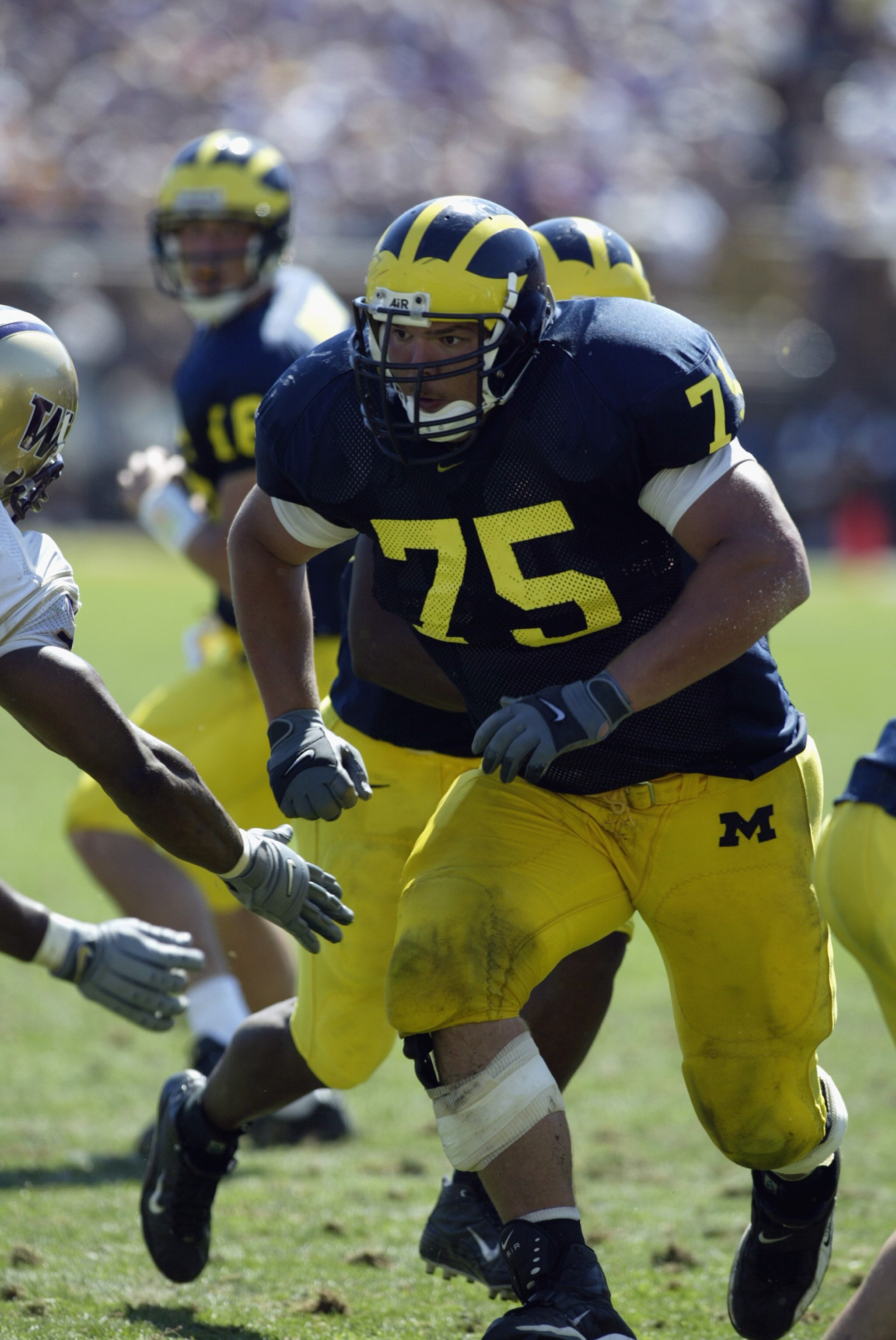 ANN ARBOR, MI - AUGUST 31:  Offensive linebacker David Baas #75 of Michigan runs after the snap during the NCAA football game against the Washington Huskies at Michigan Stadium in Ann Arbor, Michigan on August 31, 2002. The Michigan Wolverines won on a la