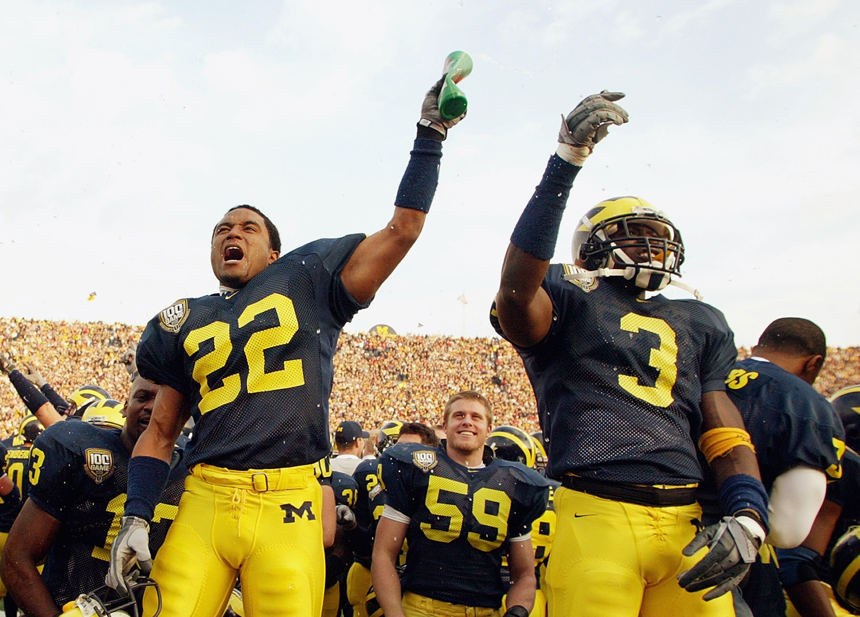 ANN ARBOR, MI - NOVEMBER 22:  Wide receiver Ross Kesler #22 and Marlin Jackson #3 of the Michigan Wolverines celebrate on the sideline during the game against the Ohio State Buckeyes during the 100th meeting of the two teams November 22, 2003 at Michigan