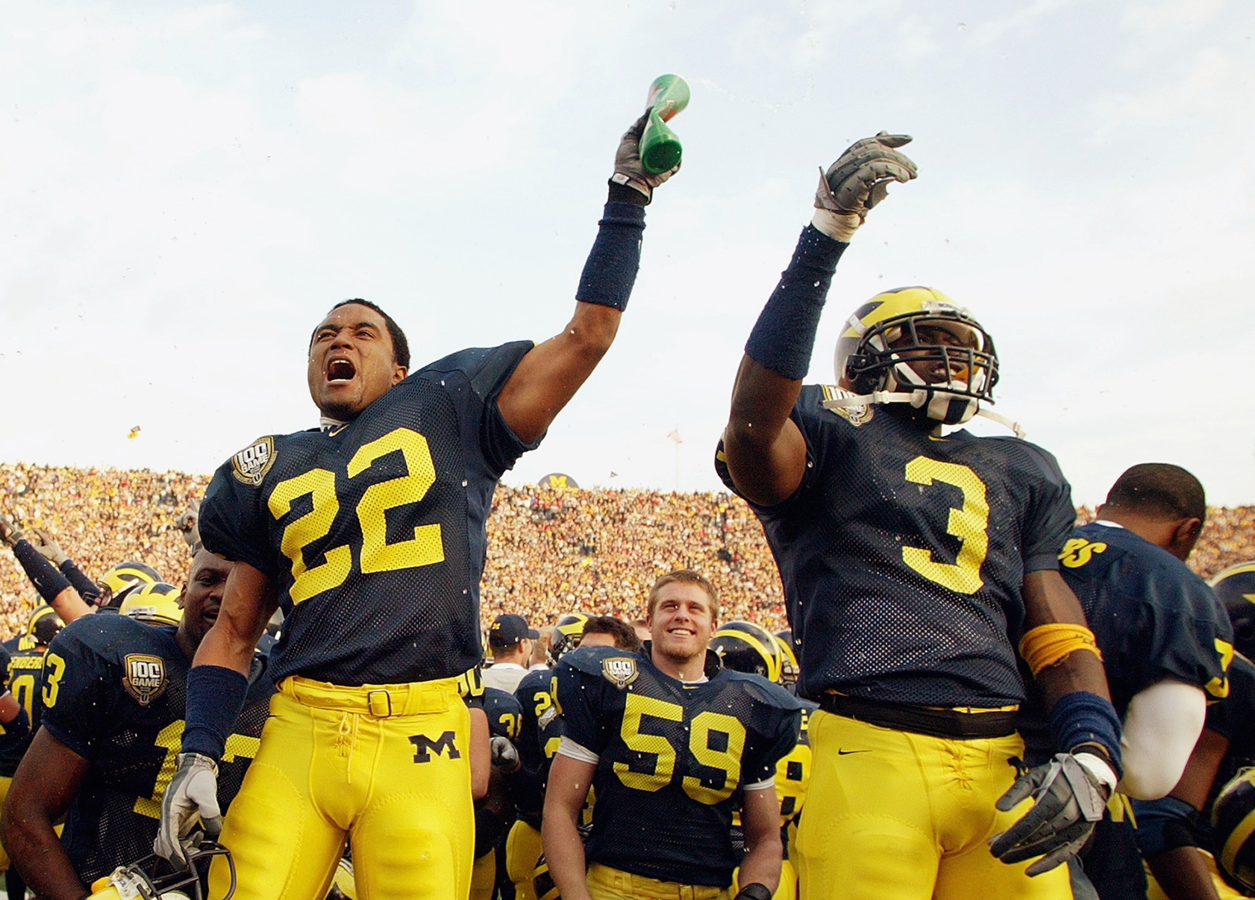 ANN ARBOR, MI - NOVEMBER 22:  Wide receiver Ross Kesler #22 and Marlin Jackson #3 of the Michigan Wolverines celebrate on the sideline during the game against the Ohio State Buckeyes during the 100th meeting of the two teams November 22, 2003 at Michigan