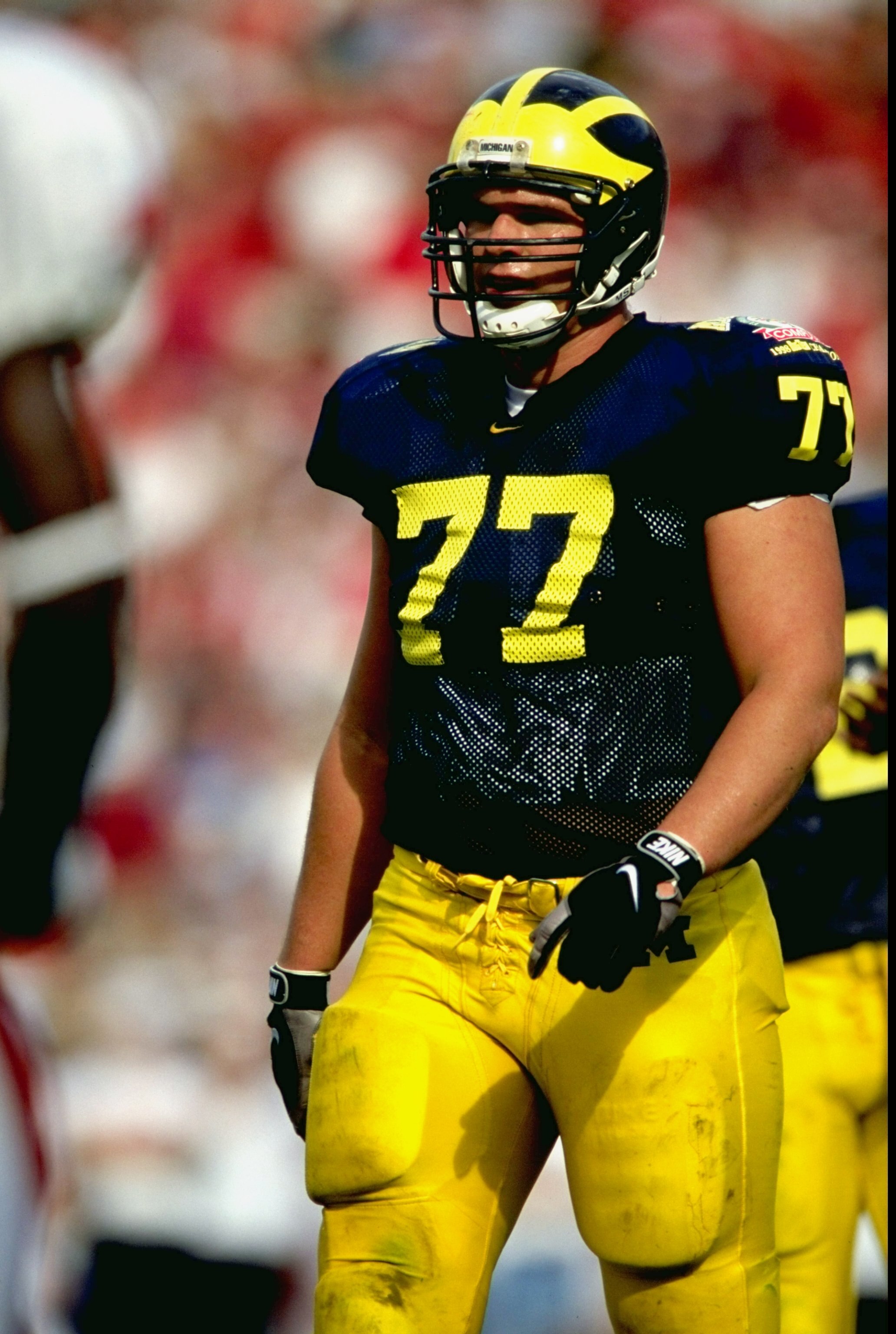 1 Jan 1999:  Jon Janson #77 of the Michigan Wolverines walking up to the front line during the Florida Citrus Bowl Game against the Arkansas Razorbacks at the Citrus Bowl in Orlando, Florida. The Wolverines defeated the Razorbacks 45-31. Mandatory Credit: