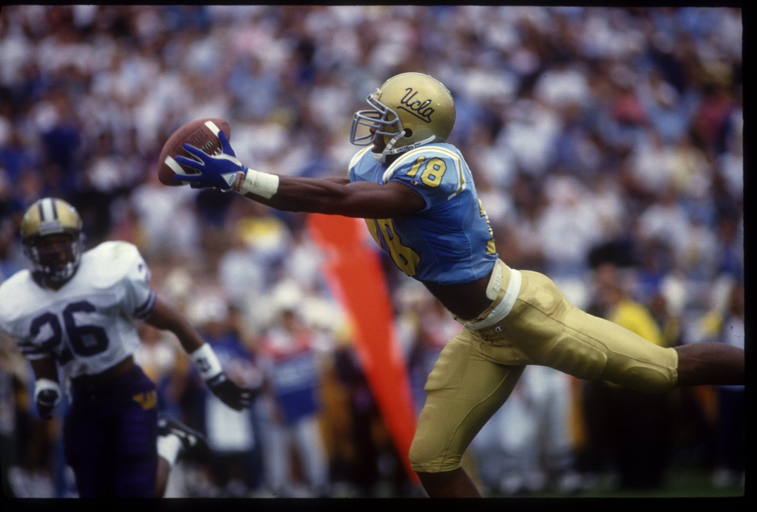 16 OCT 1993:  UCLA WIDE RECEIVER J.J. STOKES GRABS AN 18-YARD TOUCHDOWN PASS FROM QUARTERBACK WAYNE COOK IN THE SECOND QUARTER OF THE BRUINS 39-25 VICTORY OVER THE WASHINGTON HUSKIES AT THE ROSE BOWL IN PASADENA, CALIFORNIA.