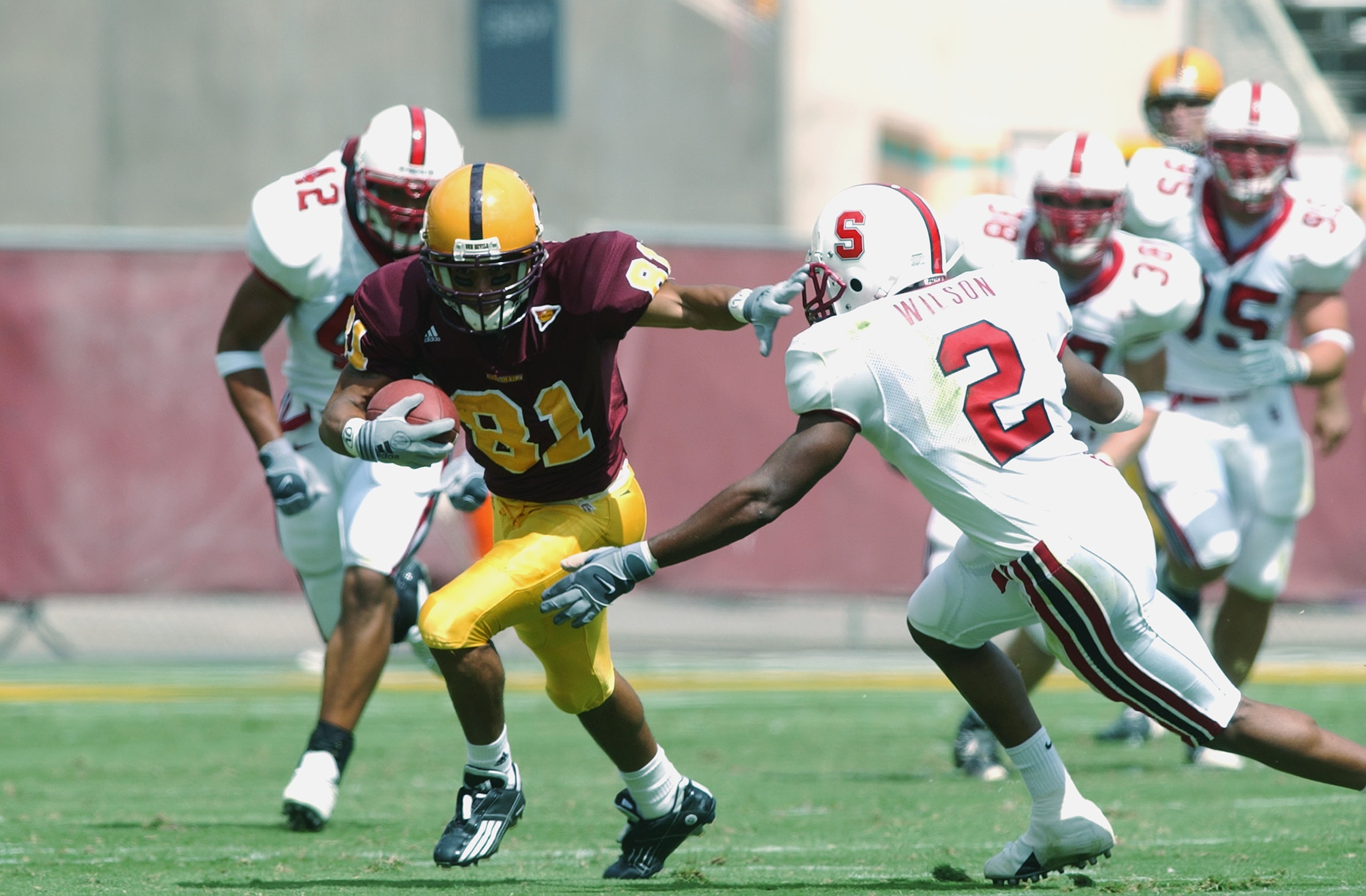TEMPE, AZ - SEPTEMBER 28:  Shaun McDonald #81 of Arizona State gets around the tackle of Stanley Wilson #2 of Stanford during the first quarter on September 28, 2002 at Sun Devil Stadium in Tempe, Arizona.  Arizona State crushed Stanford 65-24.  (Photo by