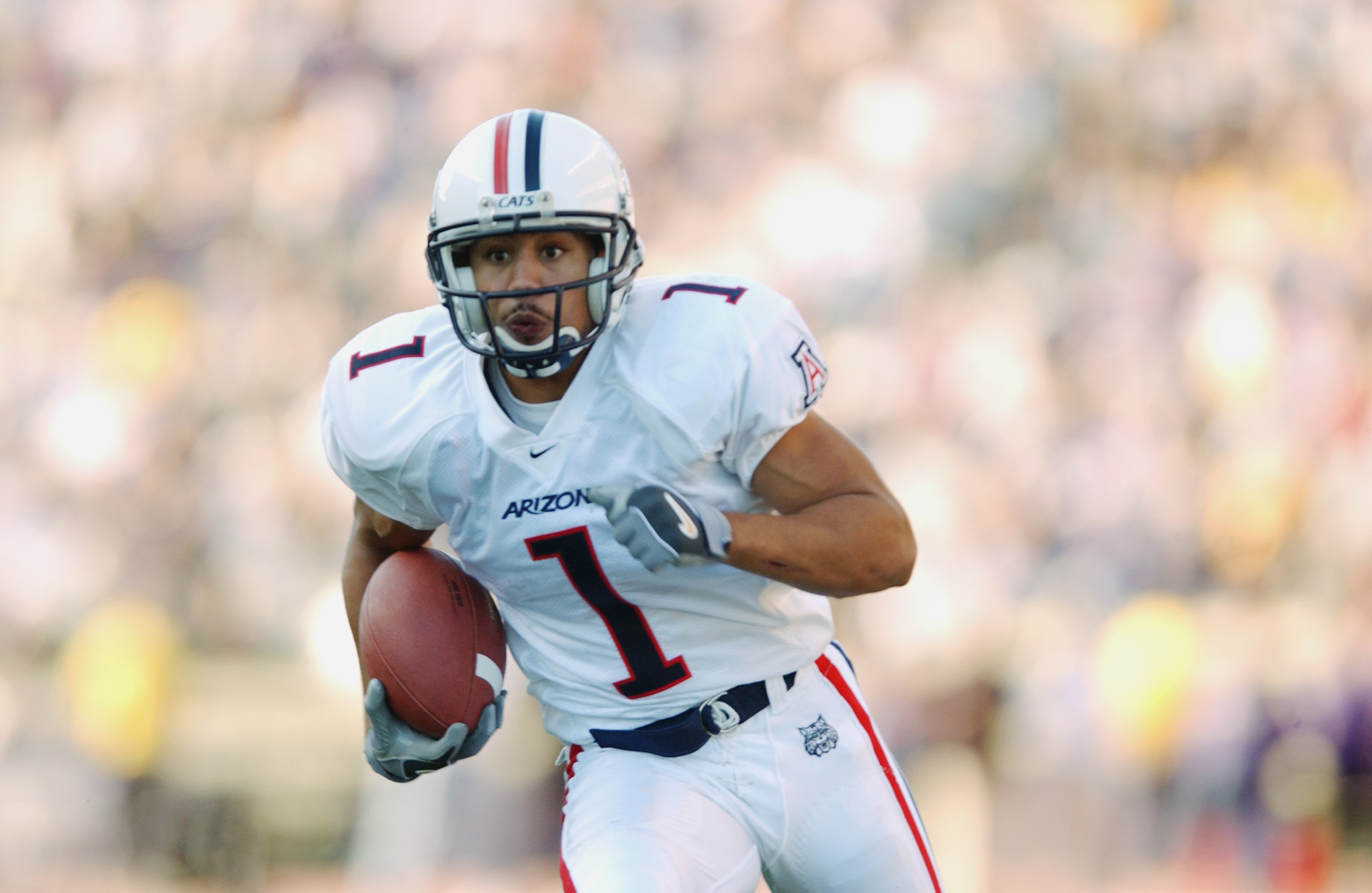 SEATTLE - OCTOBER 12:  Wide receiver Bobby Wade #1 of the Arizona Wildcats runs the ball against the Washington Huskies during the NCAA football game at Husky Stadium on October 12, 2002 in Seattle, Washington.  The University of Washington Huskies defeat