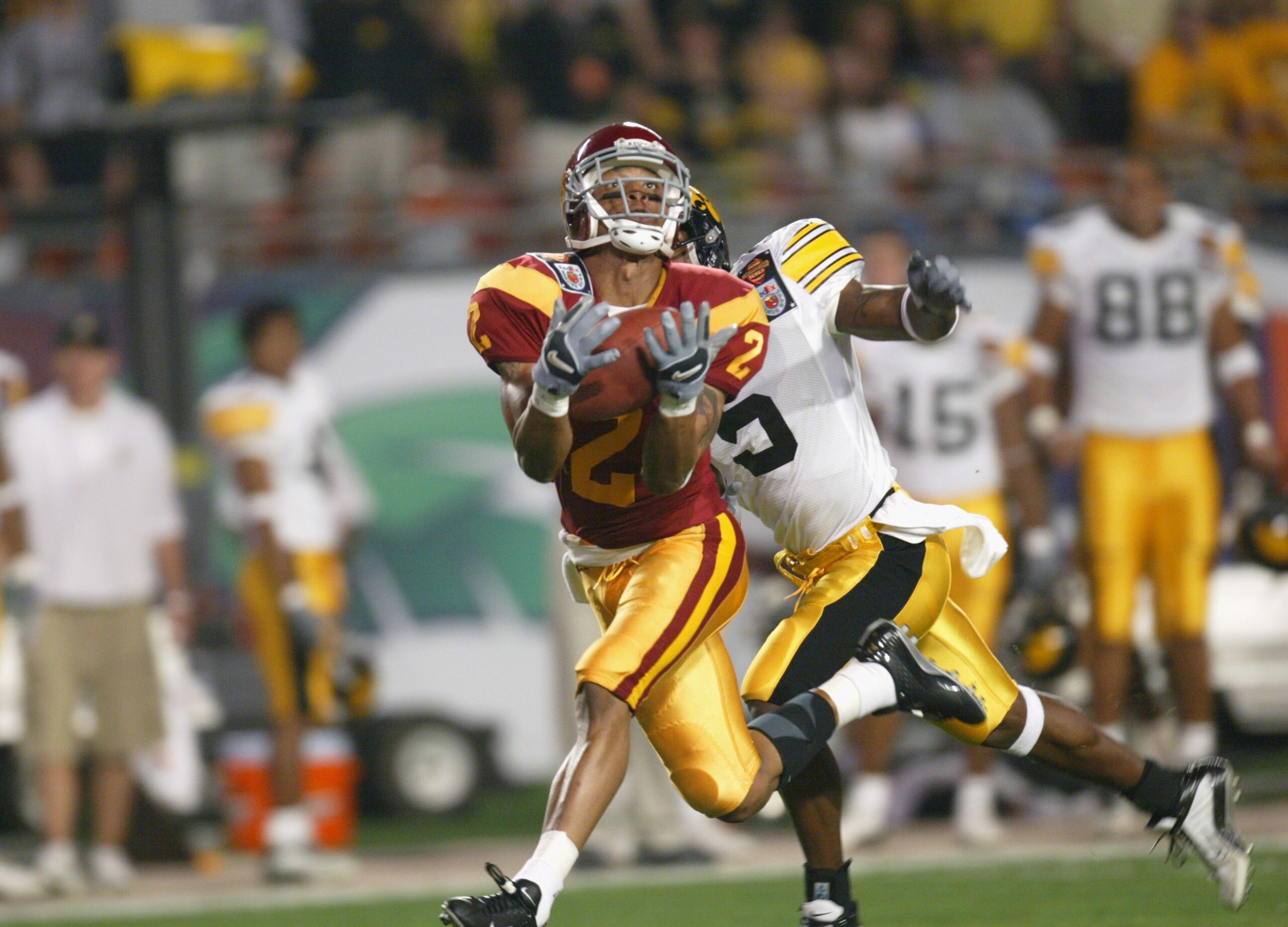 MIAMI - JANUARY 2:  Kareem Kelly #2 of USC pulls in a pass while being covered by D.J. Johnson #5 of Iowa during the FedEx Orange Bowl on January 2, 2003 at Pro Player Stadium in Miami, Florida.  USC defeated Iowa 38-17.  (Photo by Eliot J. Schechter/Gett