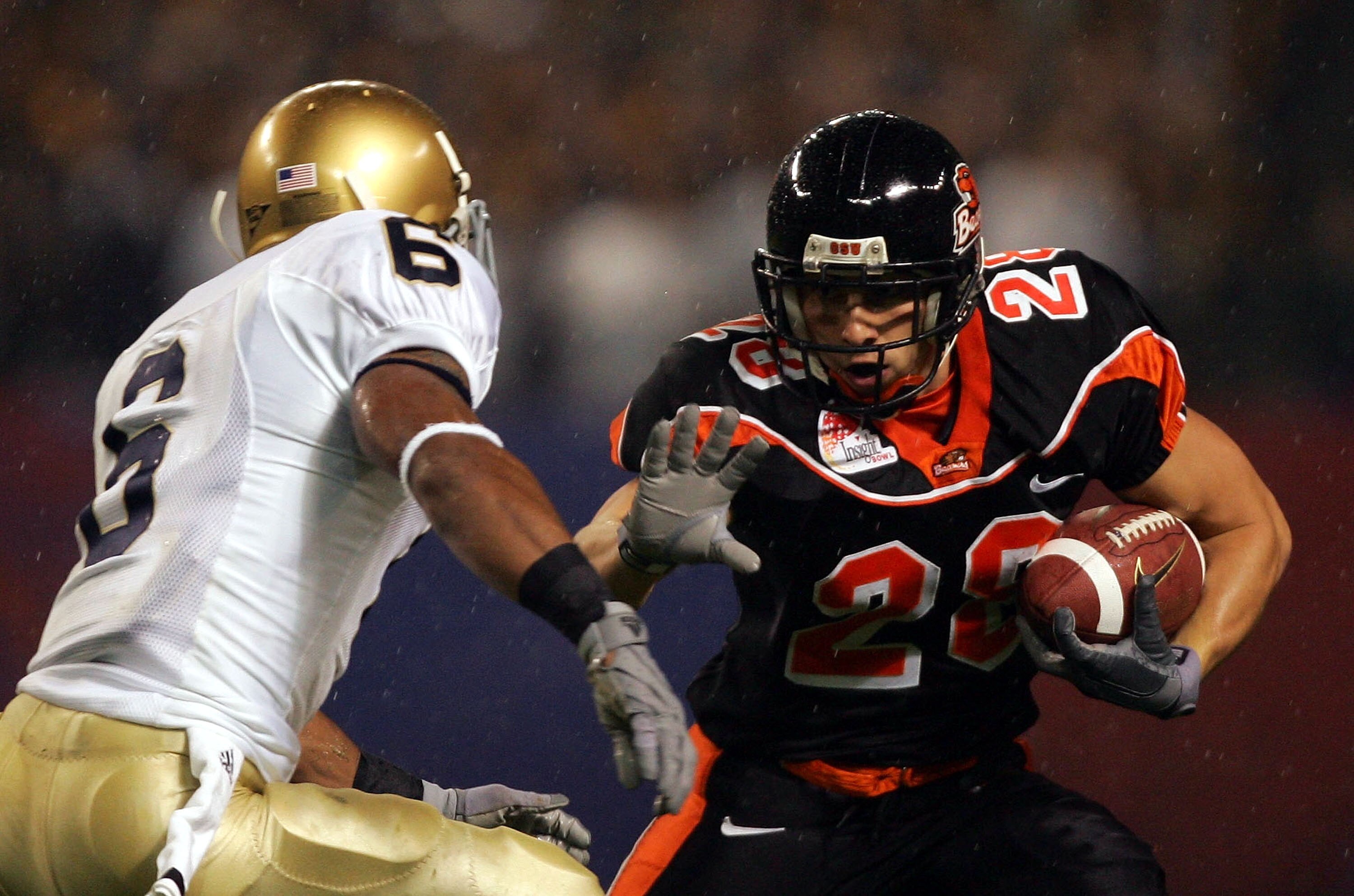 PHOENIX - DECEMBER 28:  Mike Hass #28 of Oregon State tries to get by the defense of Carlos Campbell #6 of Notre Dame in the first quarter of the Insight Bowl at Bank One Ballpark on December 28, 2004 in Phoenix, Arizona.  (Photo by Harry How/Getty Images