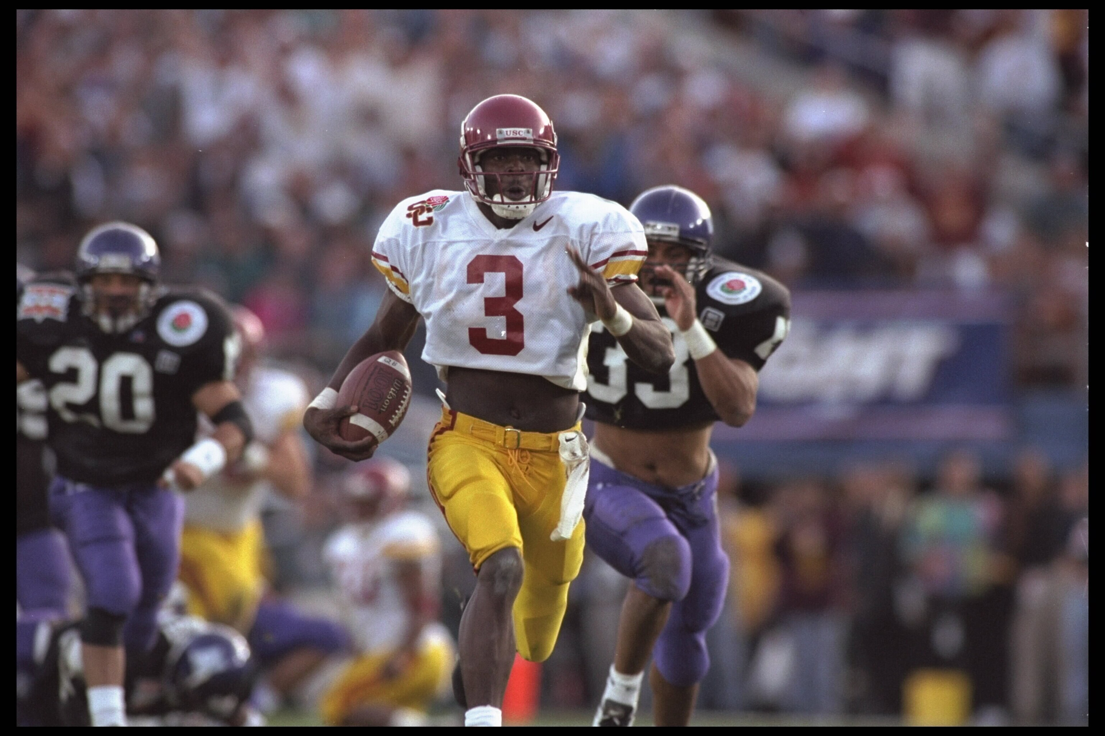 1 Jan 1996:  Wide receiver Keyshawn Johnson #3 of the University of Southern California Trojans carries his reception far downfield in front of some Northwestern Wildcat chasers including free safety William Bennett #20 and strong safety Eric Collier #33.