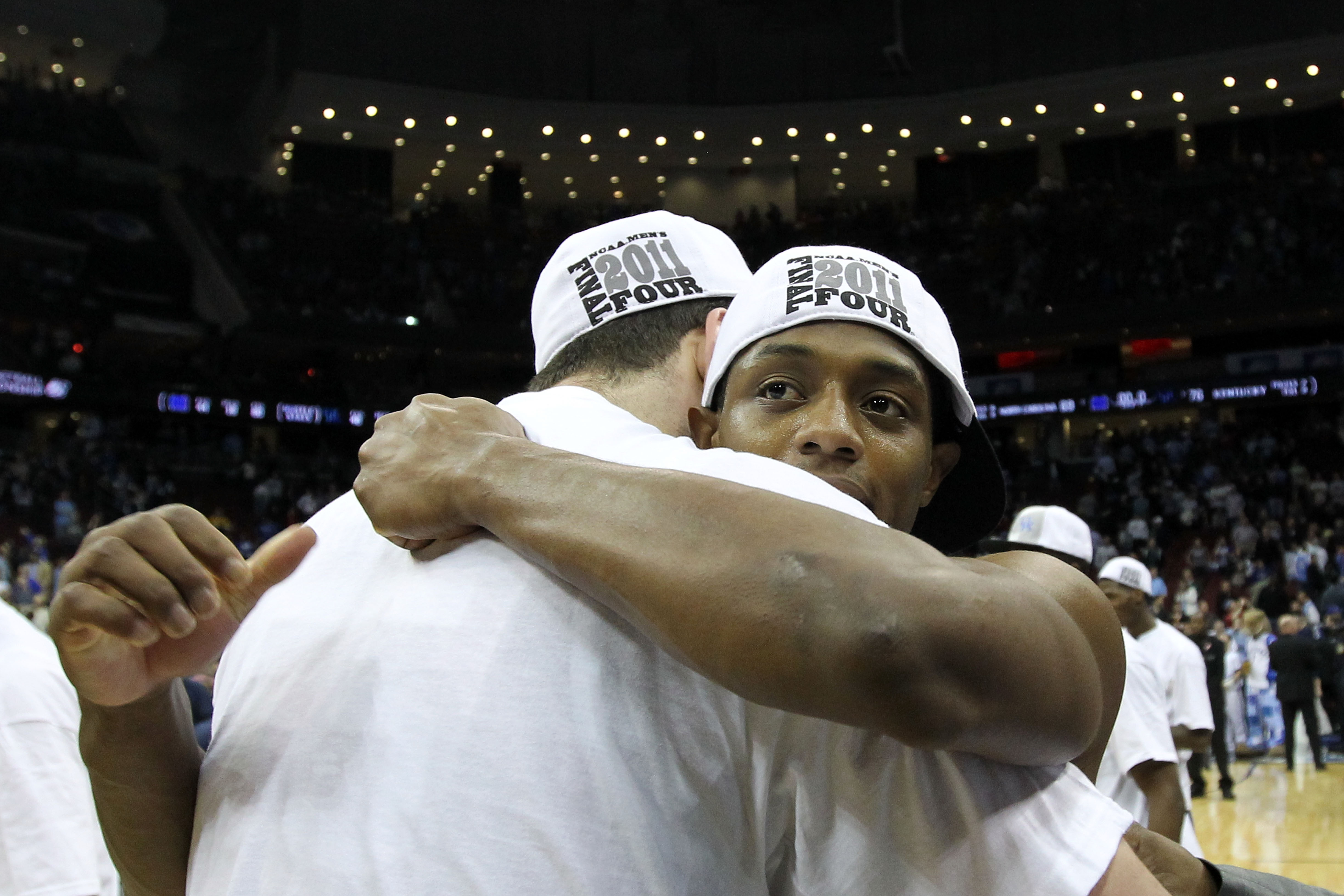 NEWARK, NJ - MARCH 27:  Josh Harrellson #55 of the Kentucky Wildcats hugs tammate Brandon Knight #12 of the Kentucky Wildcats after defeating the North Carolina Tar Heels in the east regional final of the 2011 NCAA men's basketball tournament at Prudentia