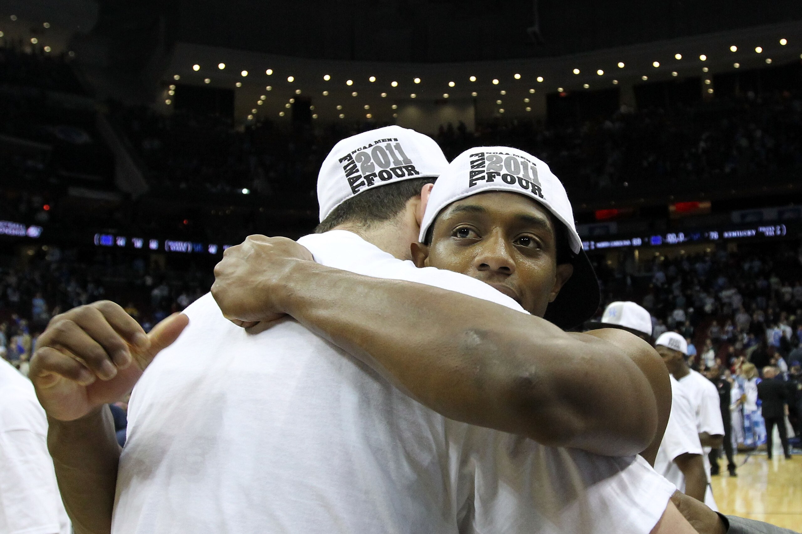 NEWARK, NJ - MARCH 27:  Josh Harrellson #55 of the Kentucky Wildcats hugs tammate Brandon Knight #12 of the Kentucky Wildcats after defeating the North Carolina Tar Heels in the east regional final of the 2011 NCAA men's basketball tournament at Prudentia