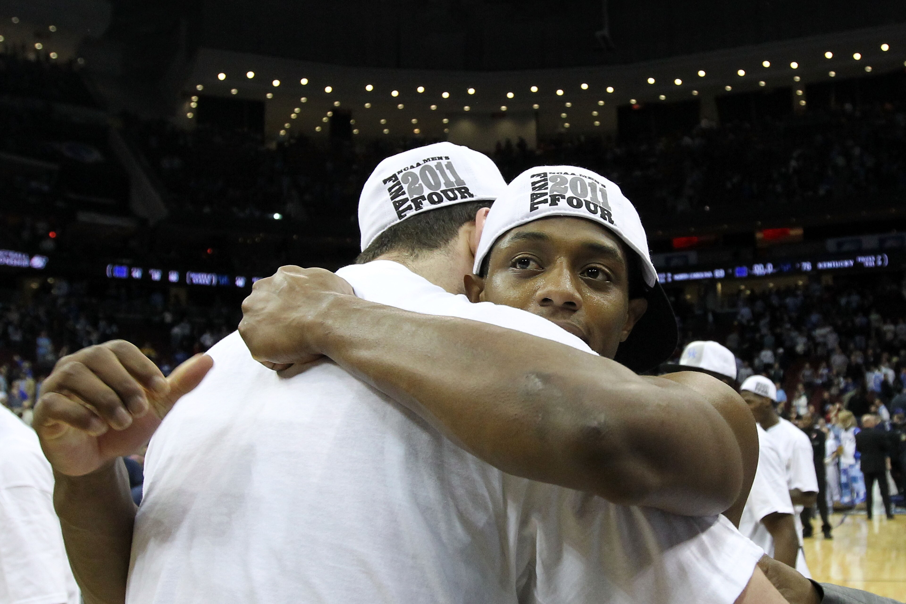 NEWARK, NJ - MARCH 27:  Josh Harrellson #55 of the Kentucky Wildcats hugs tammate Brandon Knight #12 of the Kentucky Wildcats after defeating the North Carolina Tar Heels in the east regional final of the 2011 NCAA men's basketball tournament at Prudentia