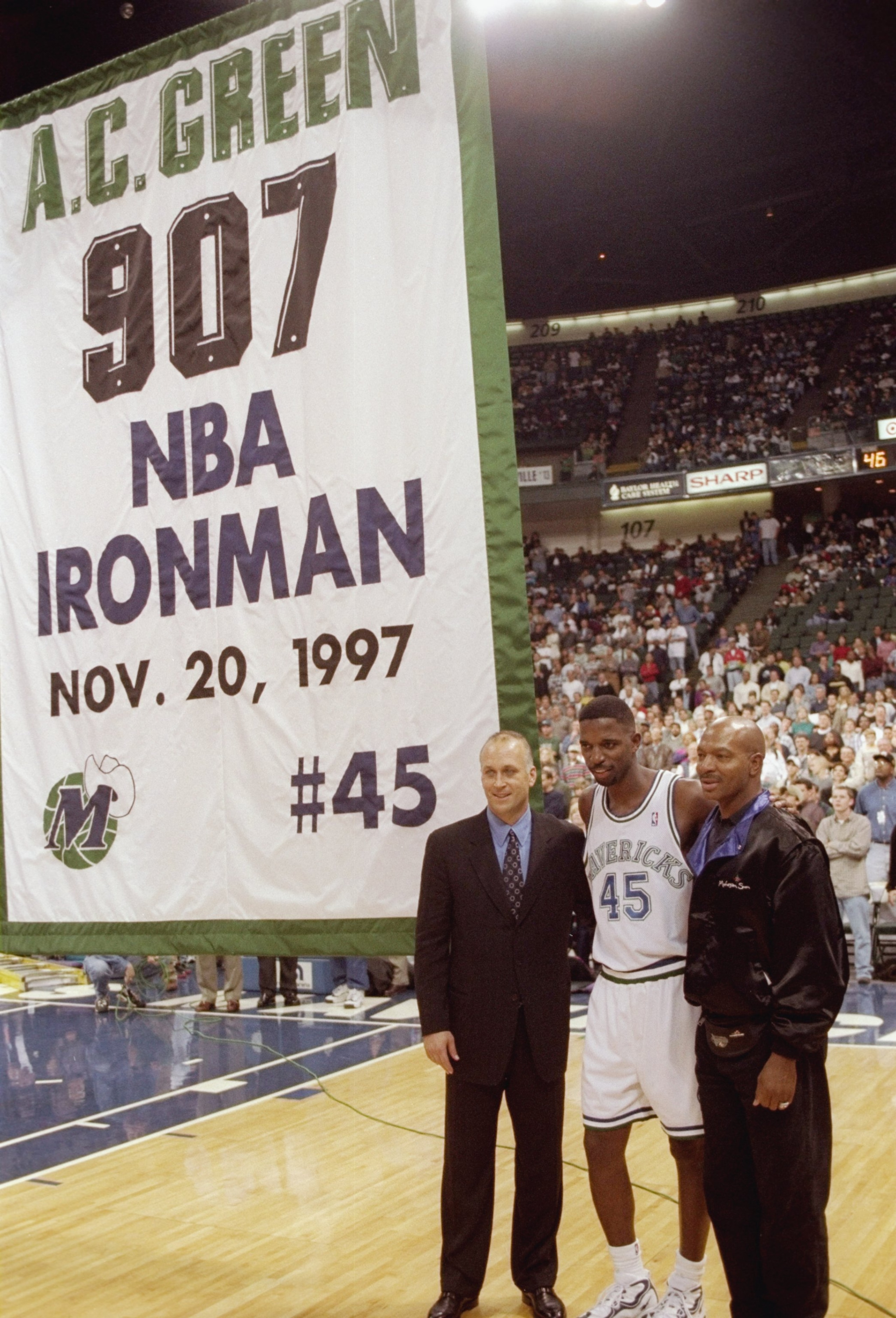 20 Nov 1997:  Forward A. C. Green of the Dallas Mavericks stands between Cal Ripken Jr. (left) and Randy Smith during a break in a game against the Golden State Warriors at the Reunion Arena in Dallas, Texas.  The Warrors won the game 101-97.  Green set t
