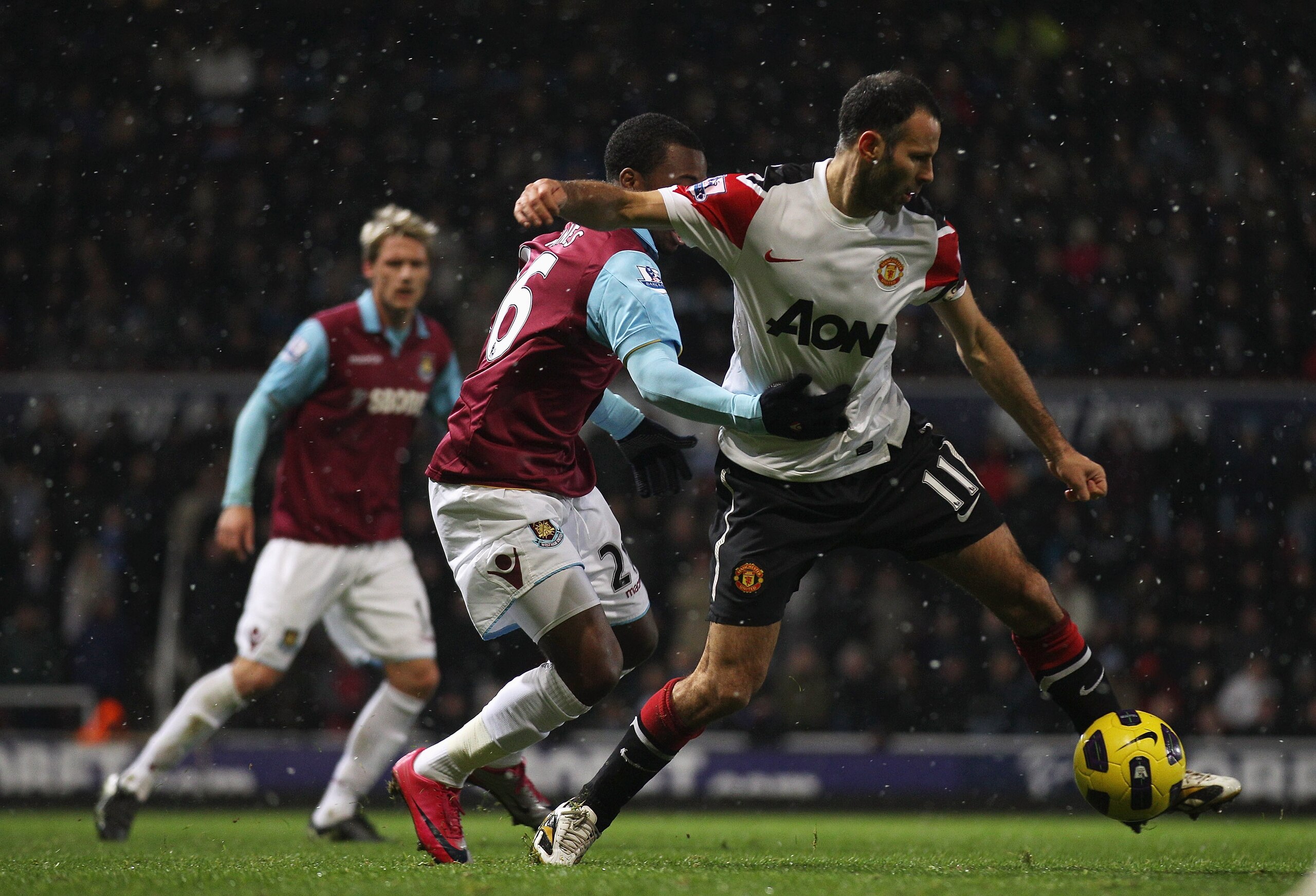 LONDON, ENGLAND - NOVEMBER 30: Ryan Giggs of Manchester United is challenged by Zavon Hines of West Ham United during the Carling Cup Quarter Final match between West Ham United and Manchester United at the Boleyn Ground on November 30, 2010 in London, En