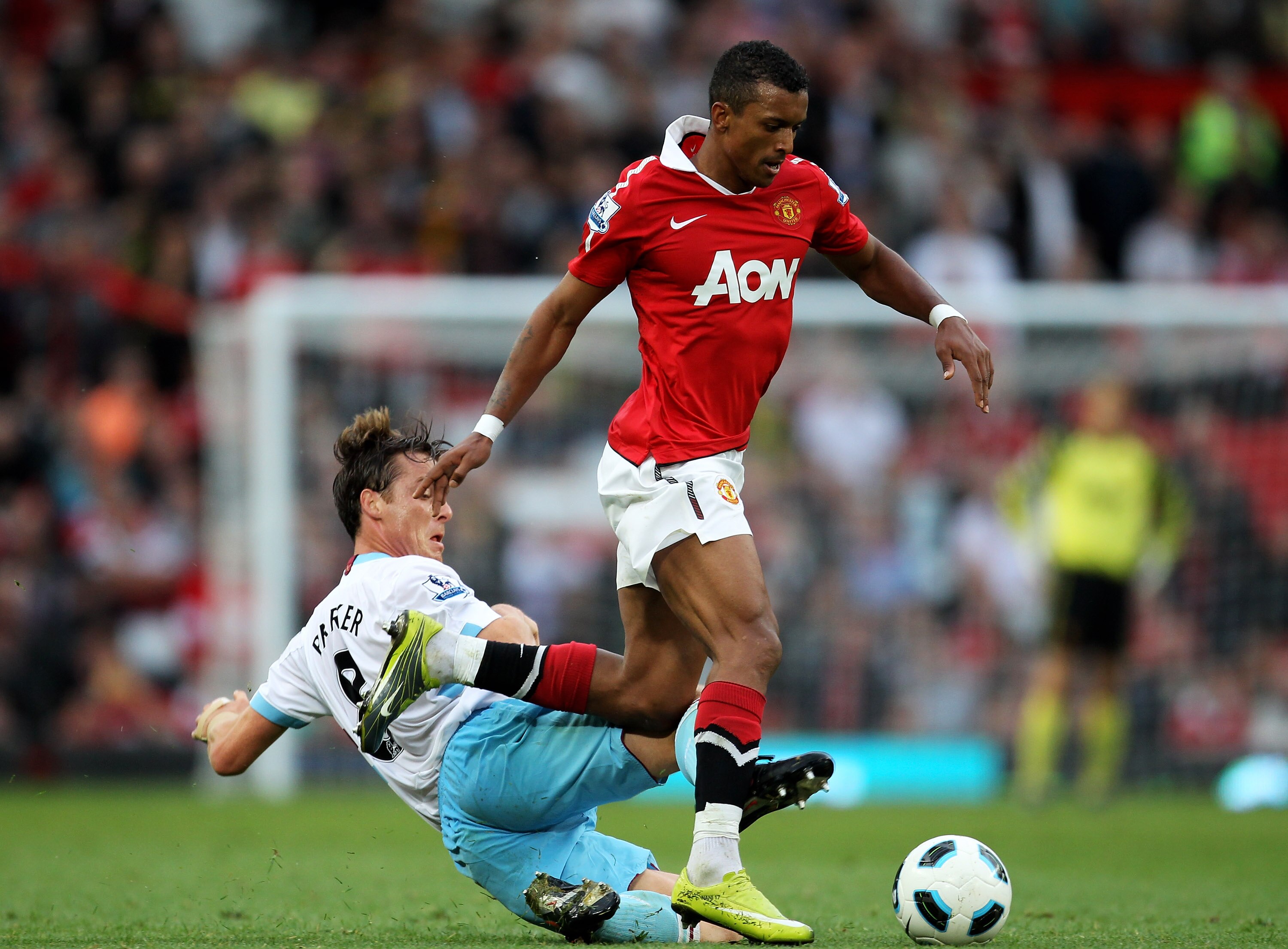 MANCHESTER, ENGLAND - AUGUST 28:  Nani of Manchester United is challenged by Scott Parker of West Ham United during the Barclays Premier League match between Manchester United and West Ham United at Old Trafford on August 28, 2010 in Manchester, England.