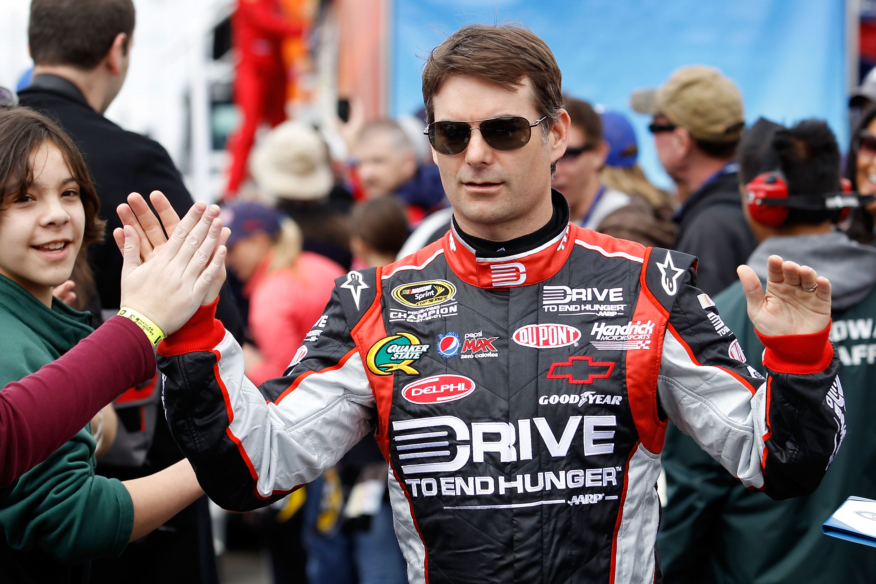 FONTANA, CA - MARCH 27:  Jeff Gordon, driver of the #24 Drive to End Hunger Chevrolet, greets fans during driver introductions for the NASCAR Sprint Cup Series Auto Club 400 at Auto Club Speedway on March 27, 2011 in Fontana, California.  (Photo by Todd W