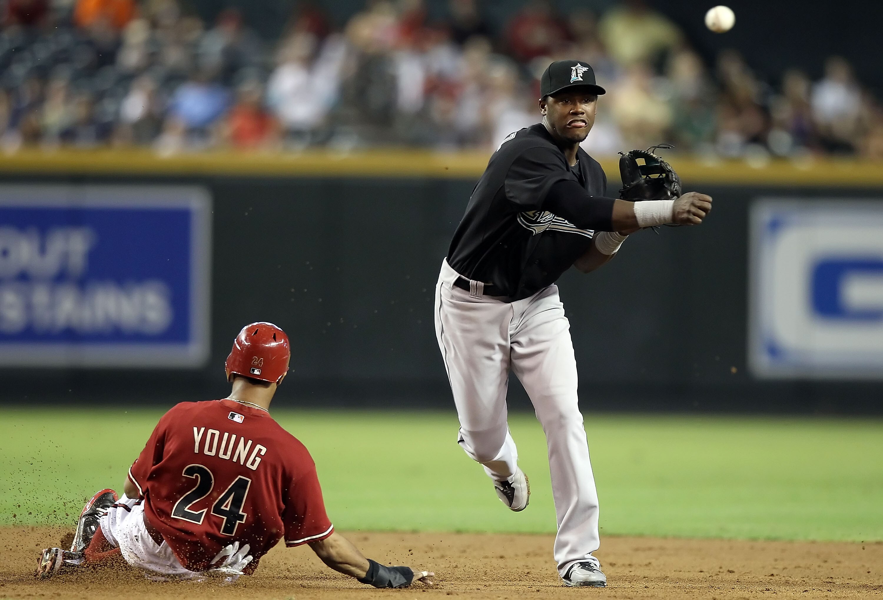 PHOENIX - JULY 11:  Infielder Hanley Ramirez #2 of the Florida Marlins throws past the sliding Chris Young #24 of the Arizona Diamondbacks to complete a double play during the third inning of the Major League Baseball game at Chase Field on July 11, 2010