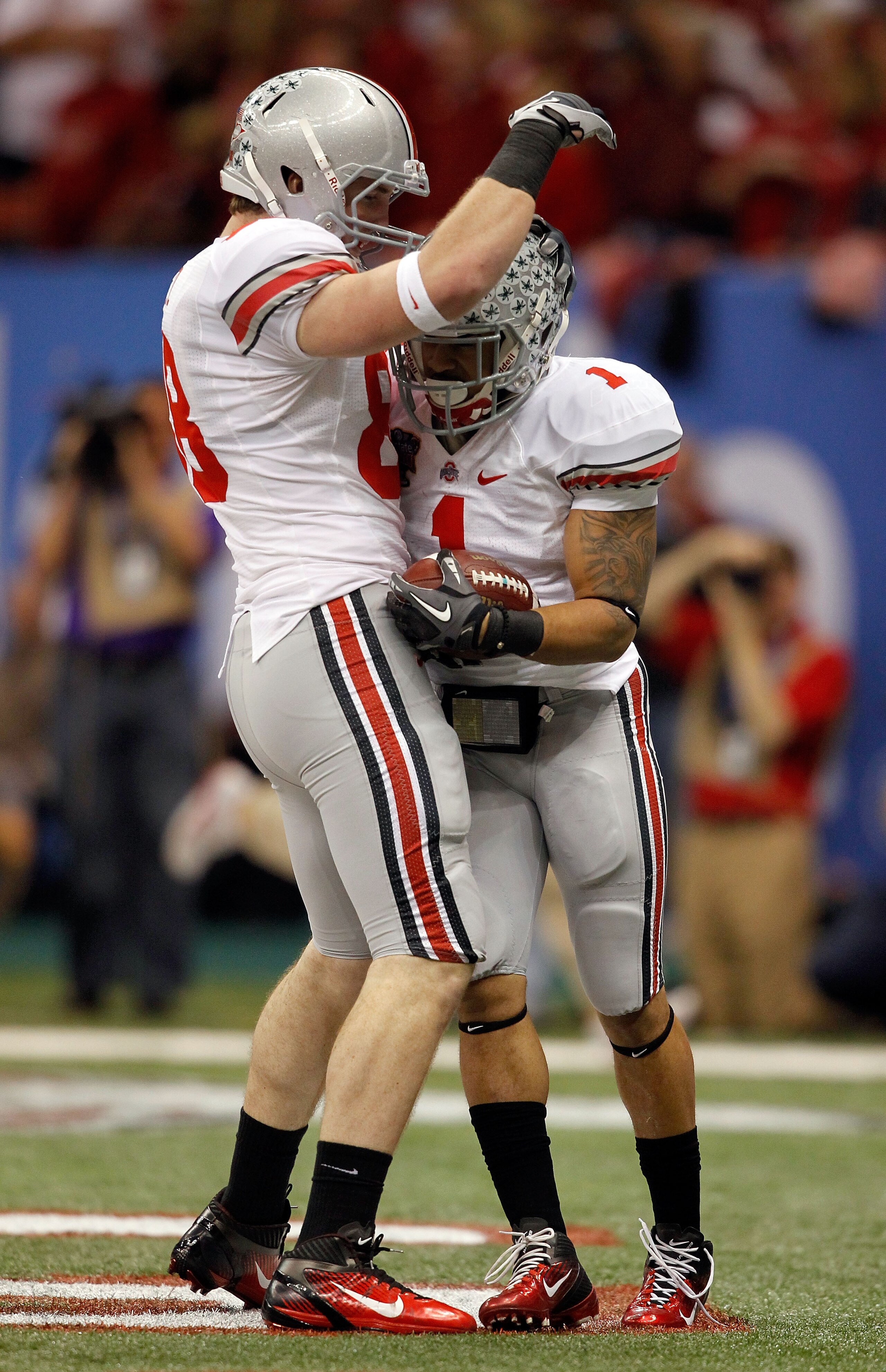 NEW ORLEANS, LA - JANUARY 04:  Dan Herron #1 of the Ohio State Buckeyes celebrates his nine-yard touchdown run with Reid Fragel #88 in the first half against the Arkansas Razorbacks during the Allstate Sugar Bowl at the Louisiana Superdome on January 4, 2