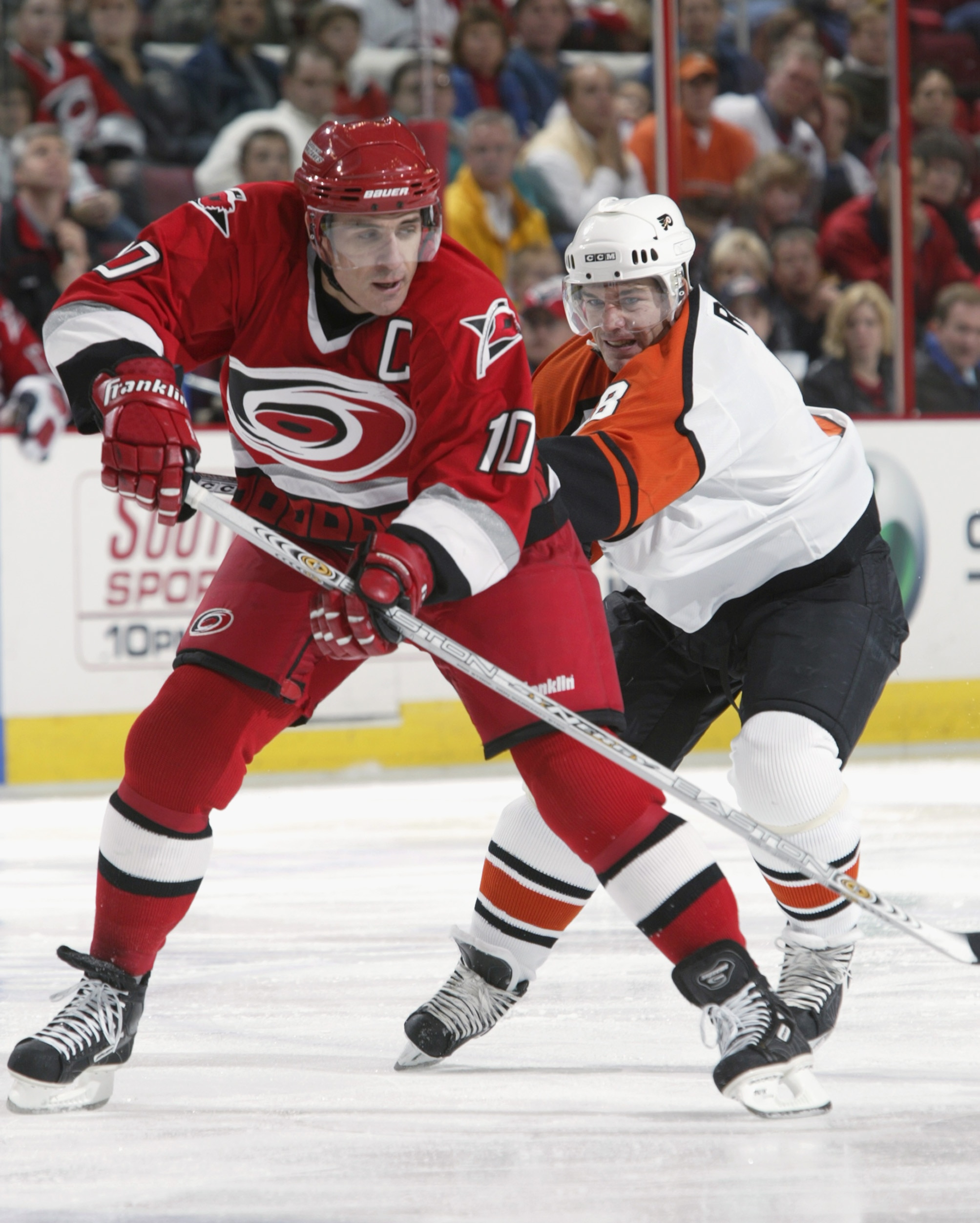RALEIGH, NC - NOVEMBER 5:  Mark Recchi #8 of the Philadelphia Flyers checks Ron Francis #10 of the Carolina Hurricanes during a game on November 5, 2002 at the RBC Center in Raleigh, North Carolina.  (Photo by Craig Jones/Getty Images/NHLI)