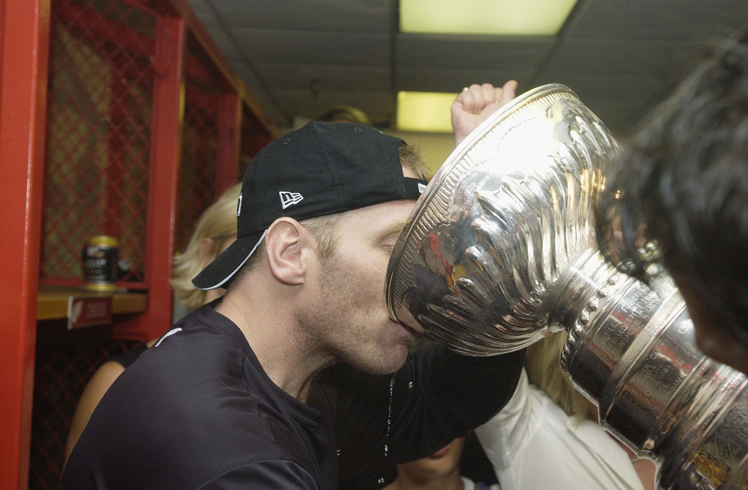 DETROIT, MI - JUNE 13:  Brett Hull of the Detroit Red Wings drinks champagne from the Stanley Cup in the locker-room after eliminating the Carolina Hurricanes during game five of the NHL Stanley Cup Finals on June 13, 2002 at the Joe Louis Arena in Detroi