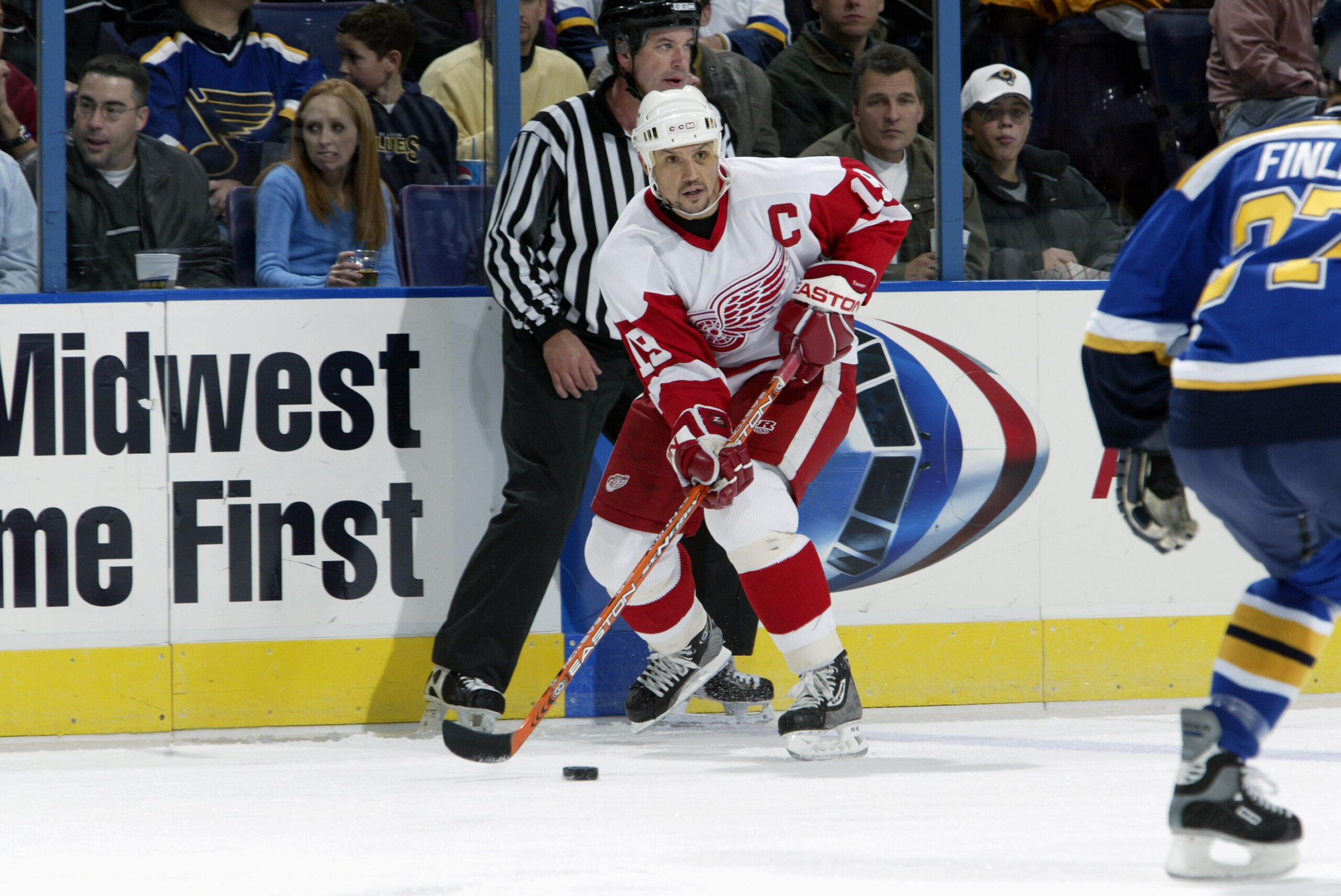 ST. LOUIS - NOVEMBER 29:  Steve Yzerman #19 of the Detroit Red Wings skates with the puck during the game against the St. Louis Blues at Savvis Center on November 29, 2003 in St. Louis, Missouri. The Red Wings defeated the Blues 2-1. (Photo by Elsa/Getty