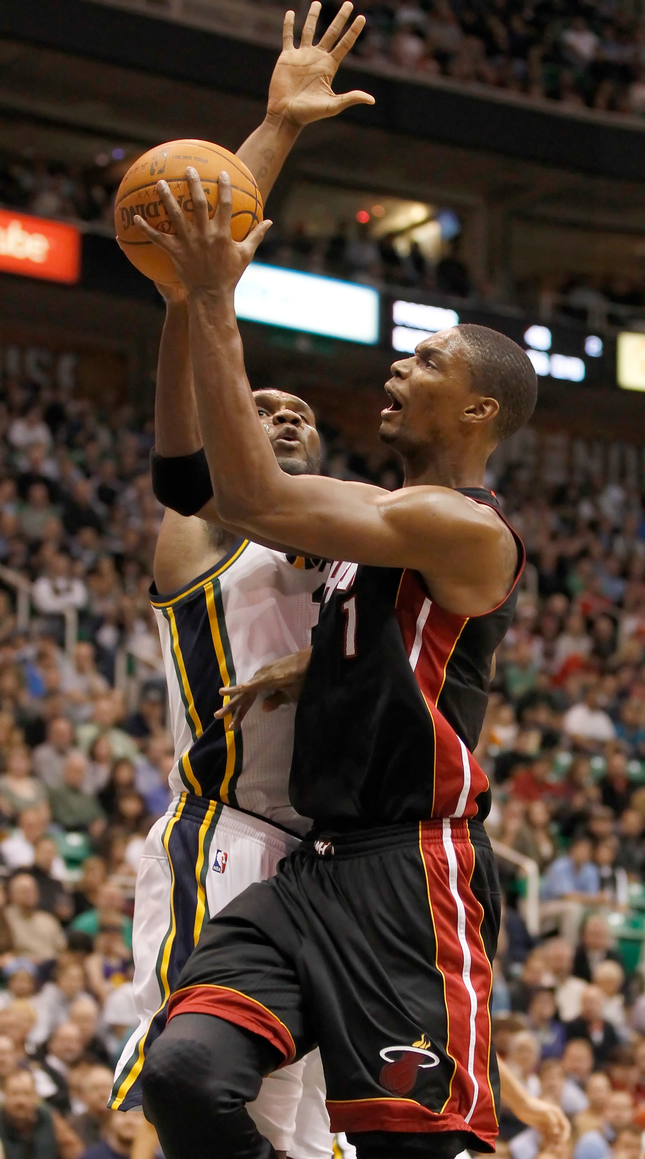 SALT LAKE CITY, UT - DECEMBER 8: Chris Bosh #1 of the Miami Heat  shoots over Al Jefferson #25 of the Utah Jazz during the first half of an NBA game December 8, 2010 at Energy Solutions Arena in Salt Lake City, Utah. NOTE TO USER:  User expressly acknowle