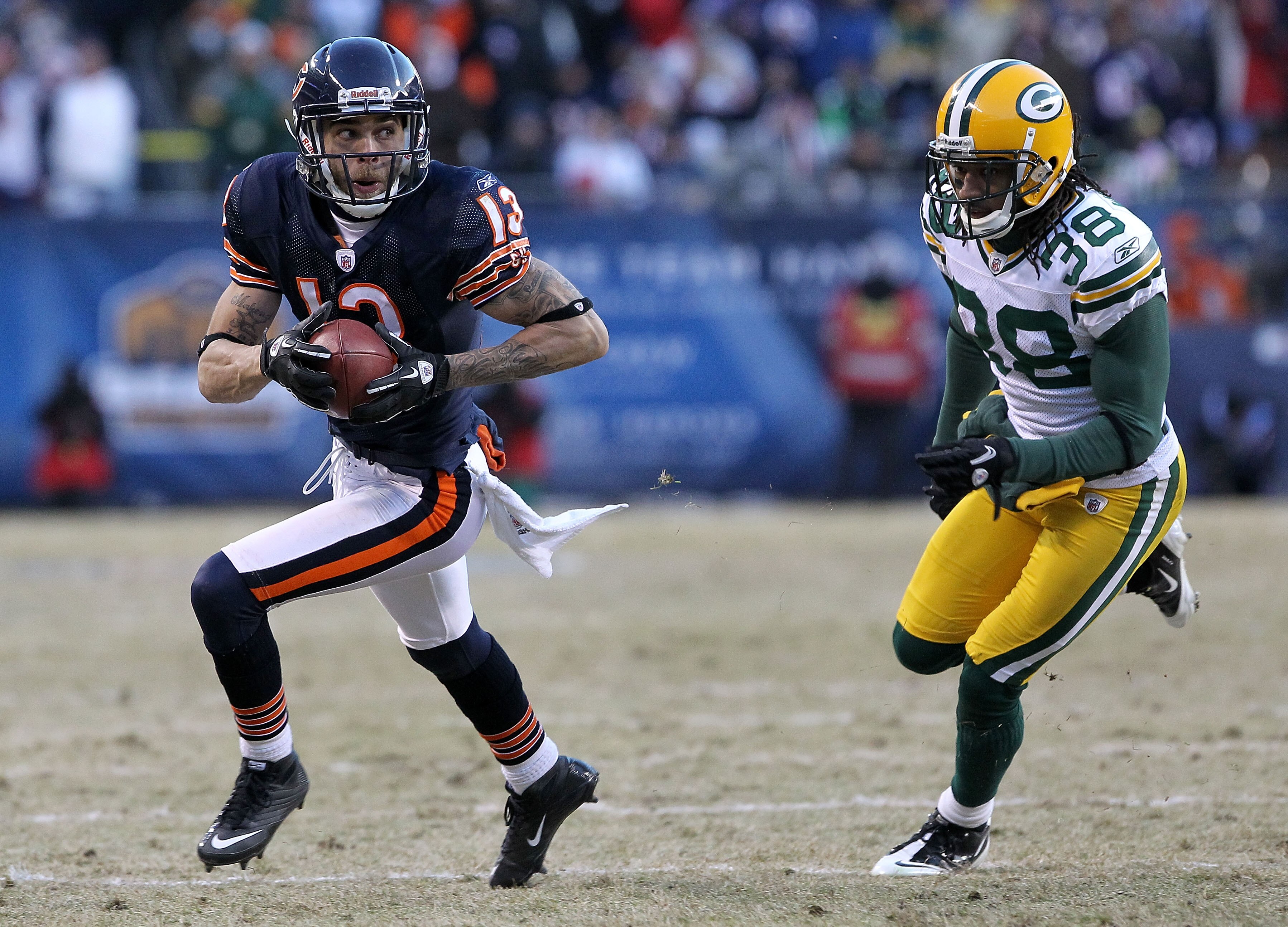 CHICAGO, IL - JANUARY 23:  Johnny Knox #13 of the Chicago Bears runs ahead of Tramon Williams #38 of the Green Bay Packers for a 32-yard gain in the fourth quarter in the NFC Championship Game at Soldier Field on January 23, 2011 in Chicago, Illinois.  (P