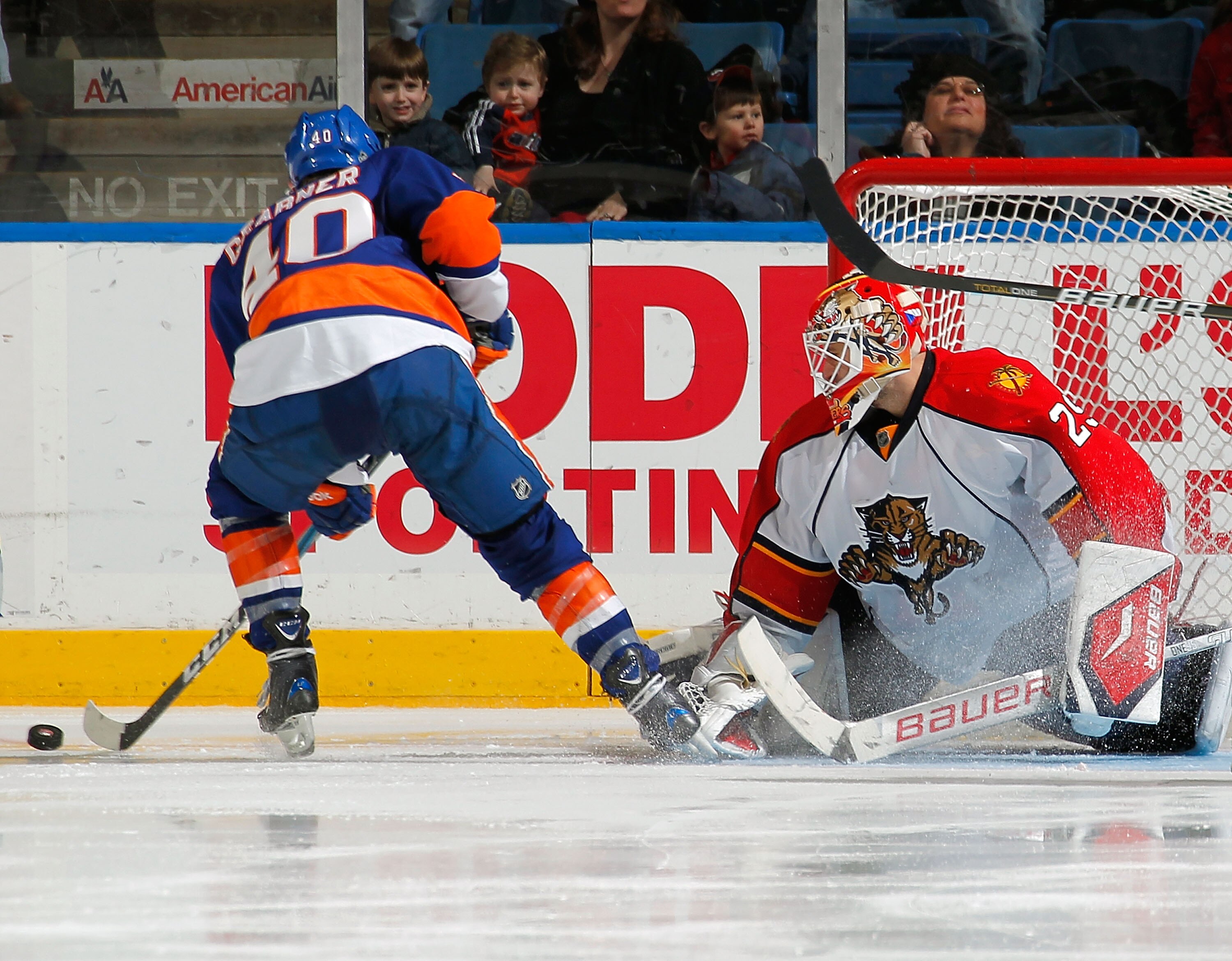 UNIONDALE, NY - FEBRUARY 21:  Goalie Tomas Vokoun #29 of the Florida Panthers knocks the puck away from Michael Grabner #40 of the New York Islanders during an NHL hockey game at the Nassau Coliseum on February 21, 2011 in Uniondale, New York.  (Photo by