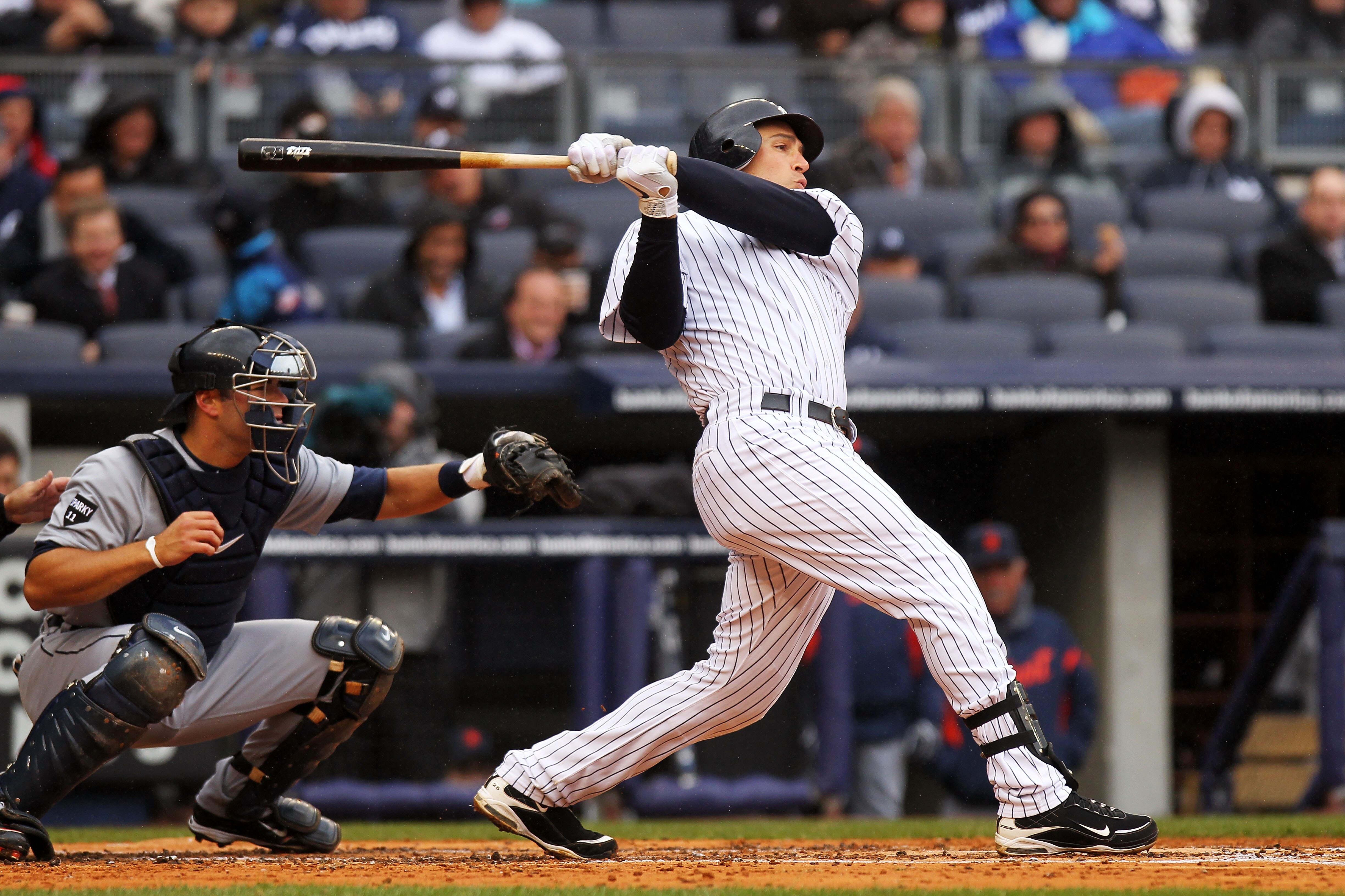 NEW YORK, NY - MARCH 31:  Mark Teixeira #25 of the New York Yankees hits a 3-run homer in the bottom of the third inning against the Detroit Tigers on Opening Day at Yankee Stadium on March 31, 2011 in the Bronx borough of New York City. (Photo by Nick La