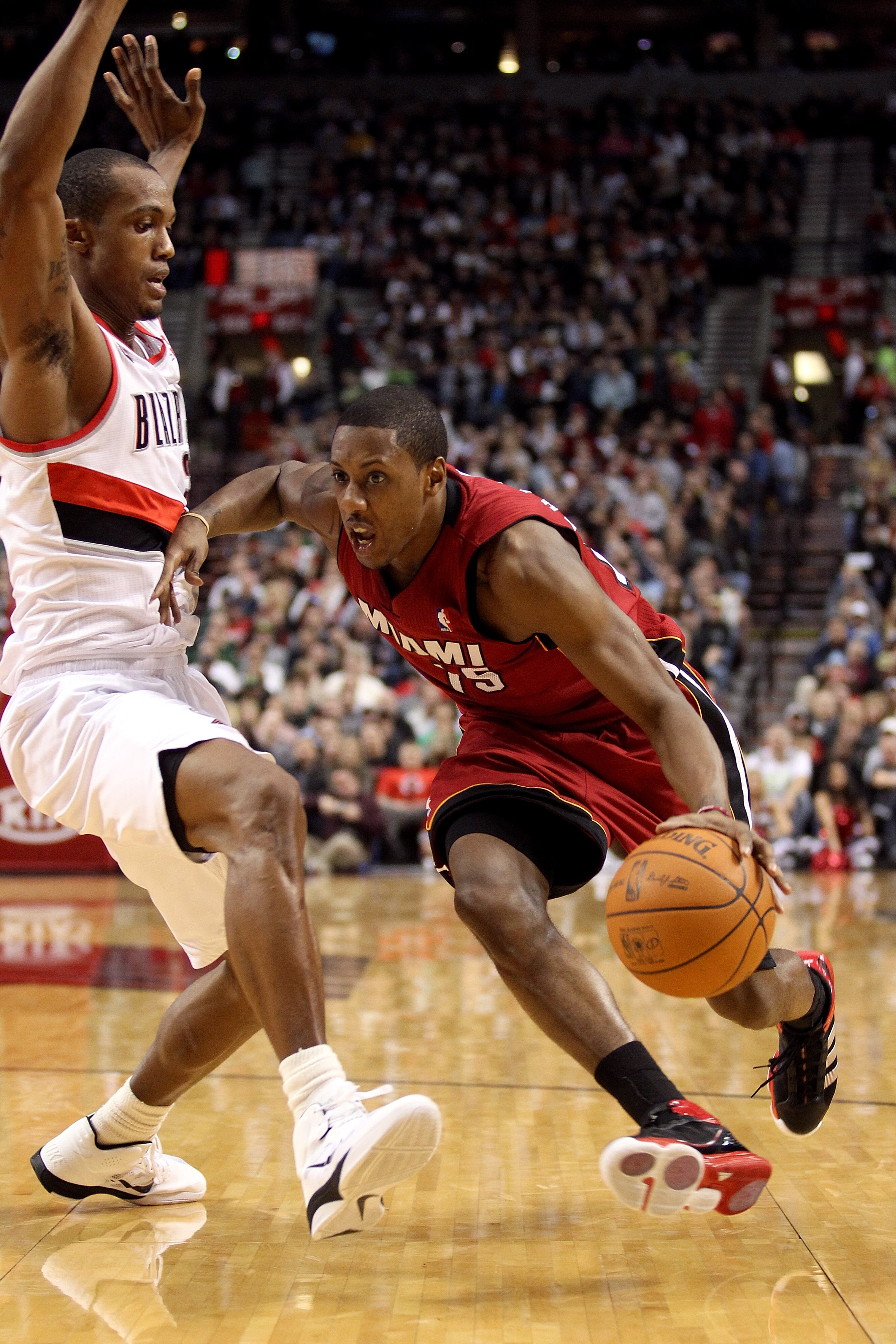 PORTLAND, OR - JANUARY 09: Mario Chalmers #15 of the Miami Heat drives against Dante Cunningham #33 of the Portland Trail Blazers during a game on January 9, 2011 at the Rose Garden Arena in Portland, Oregon. NOTE TO USER: User expressly acknowledges and