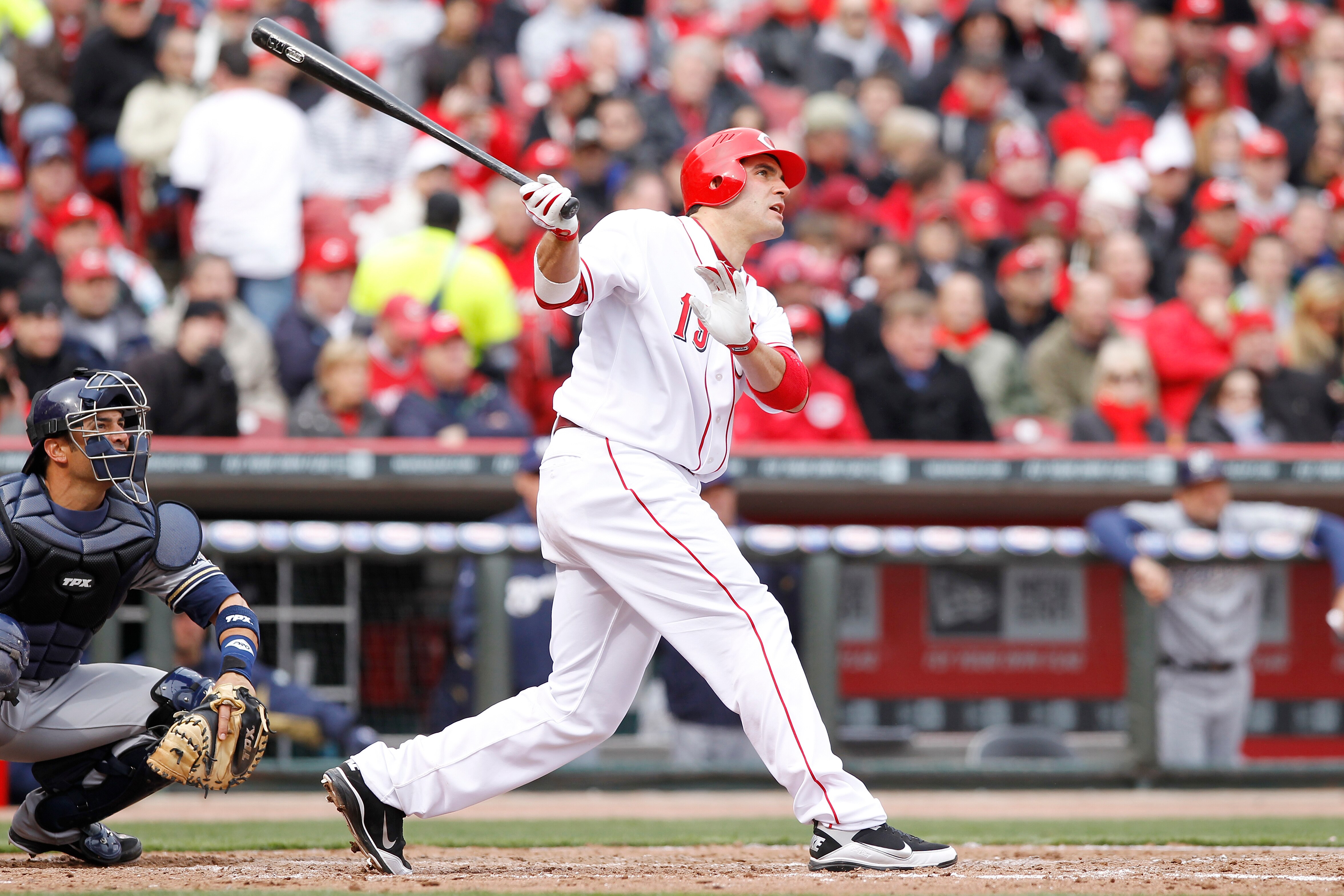 CINCINNATI, OH - MARCH 31: Joey Votto #19 of the Cincinnati Reds hits a home run in the seventh inning against the Milwaukee Brewers in the opening day game at Great American Ballpark on March 31, 2011 in Cincinnati, Ohio. The Reds won 7-6. (Photo by Joe